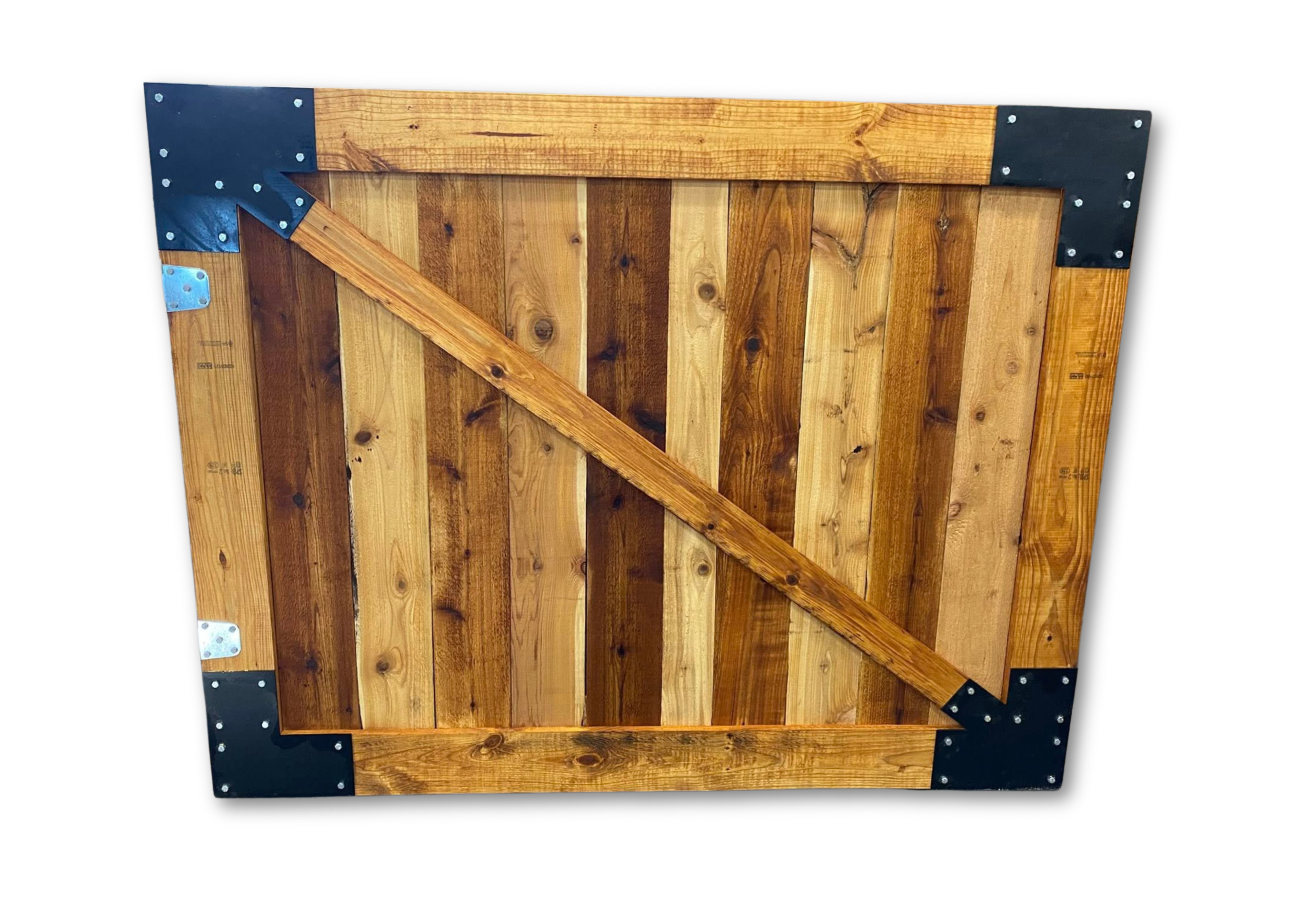 A handcrafted cedar barn door featuring custom black steel corner brackets and a diagonal support brace. Built for strength, style, and Texas durability by Dean Furniture Artist.