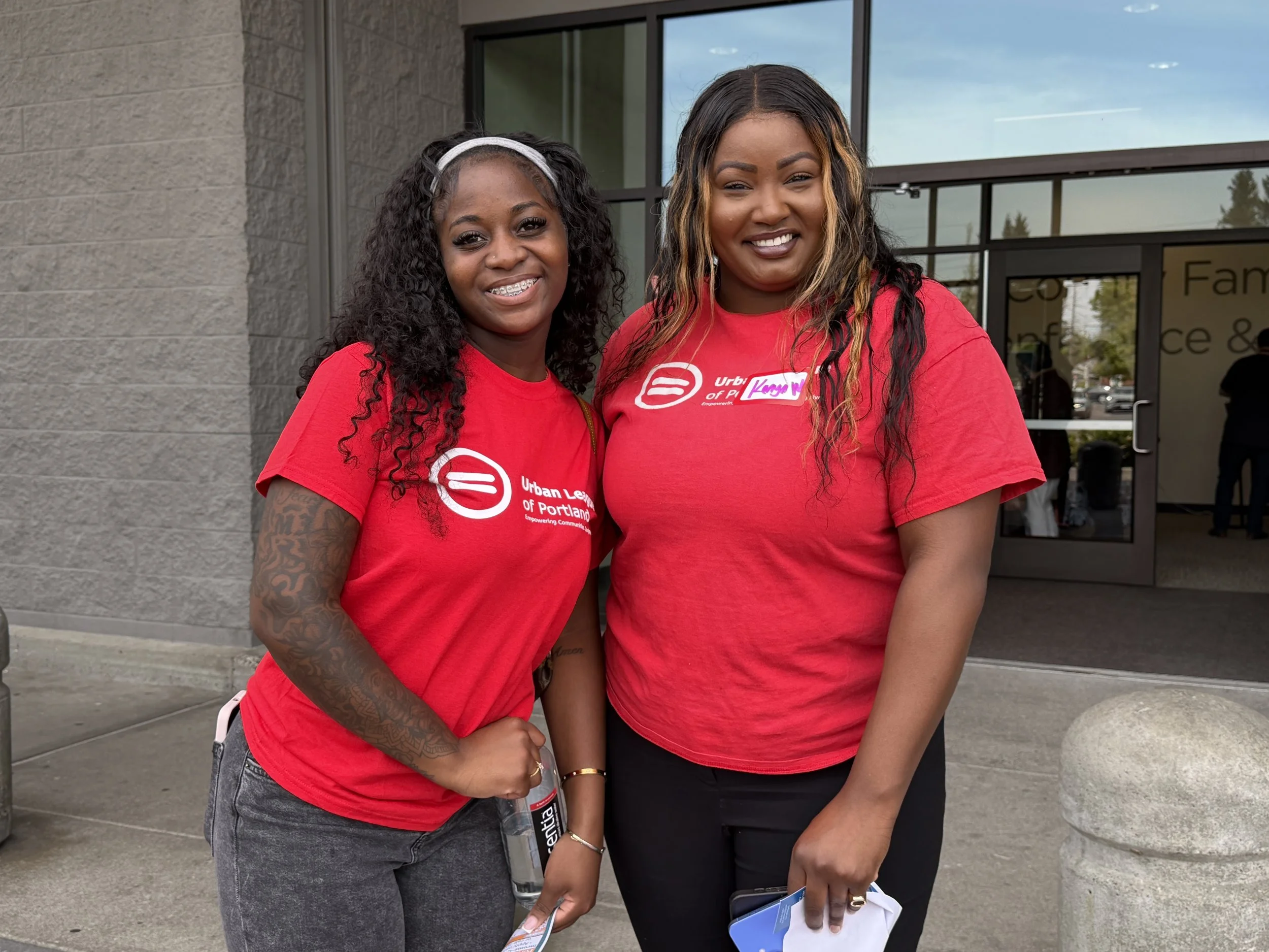 Two women in red T-shirts smiling at CSN Nonprofit Connect