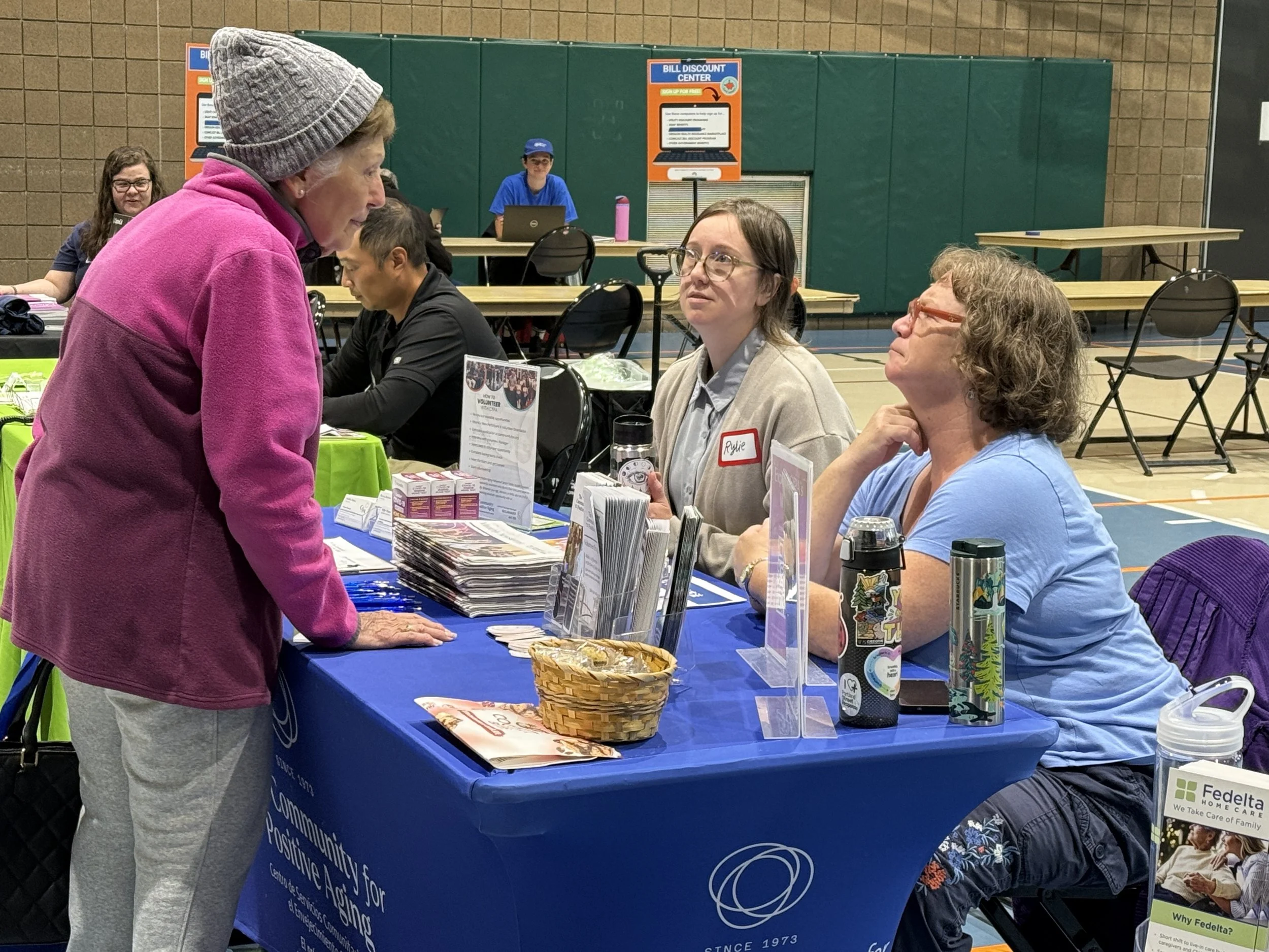 Women talking at table at Community Resource Fair