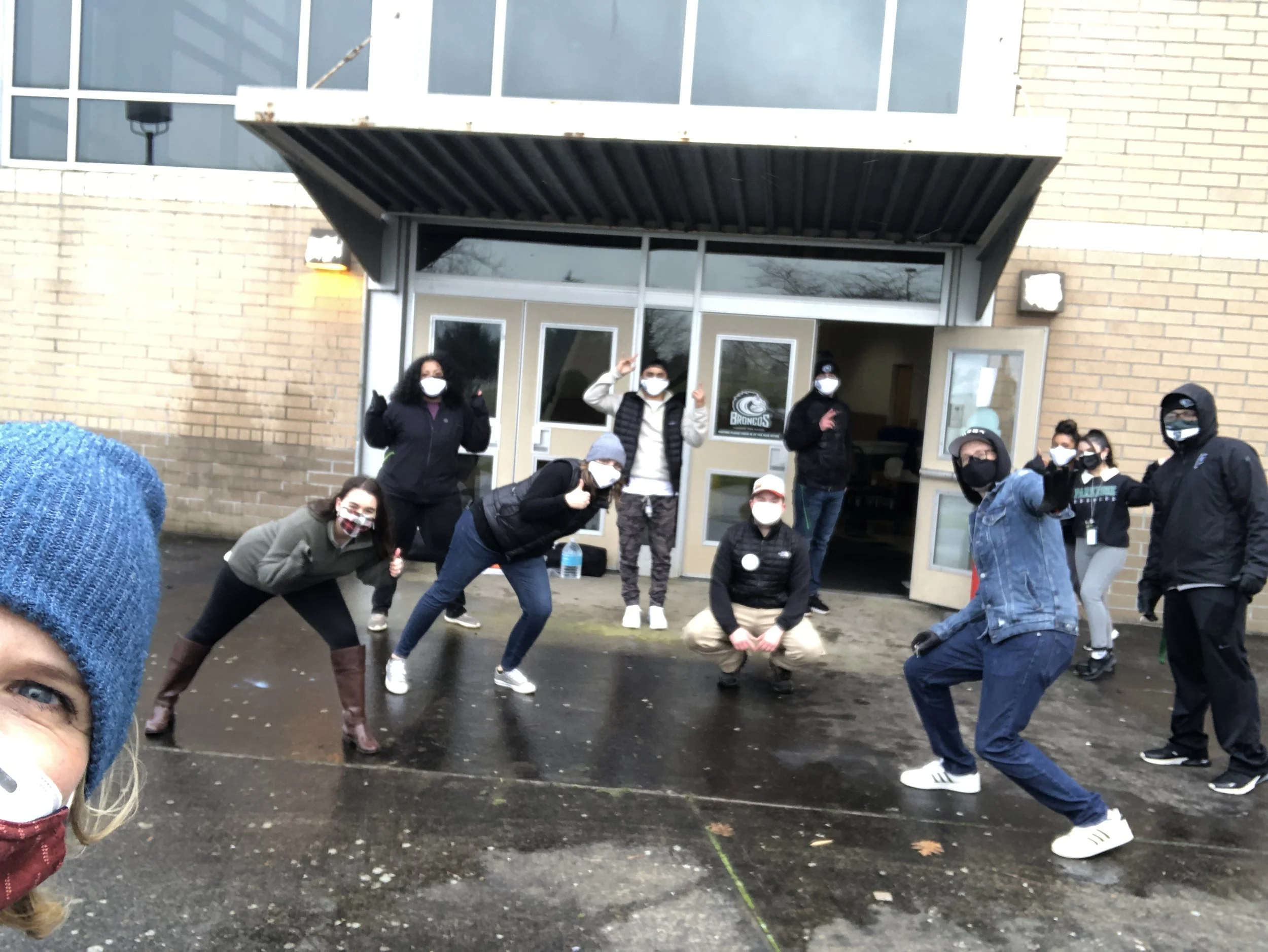  A group of CSN partner organization staff members posing outside a building entrance at a community event in Portland, Oregon. 