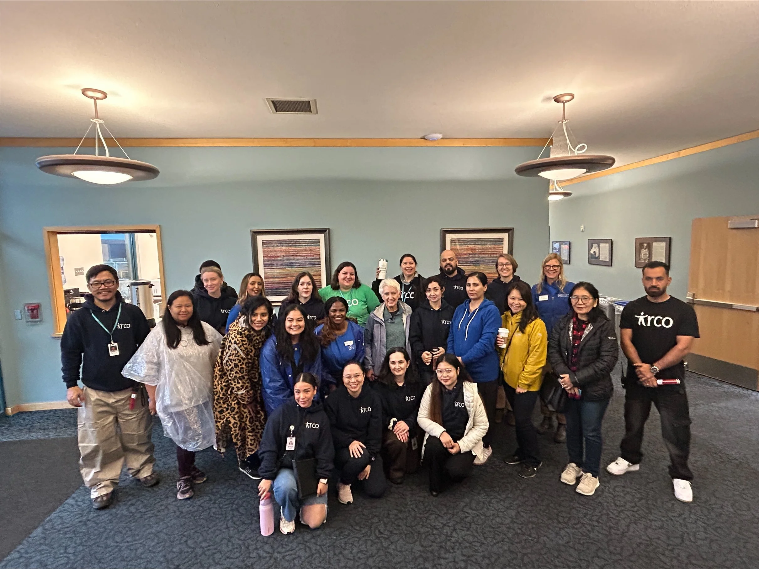  A large group of IRCO and CSN partner organization staff posing together at an indoor community networking event in Portland, Oregon. 