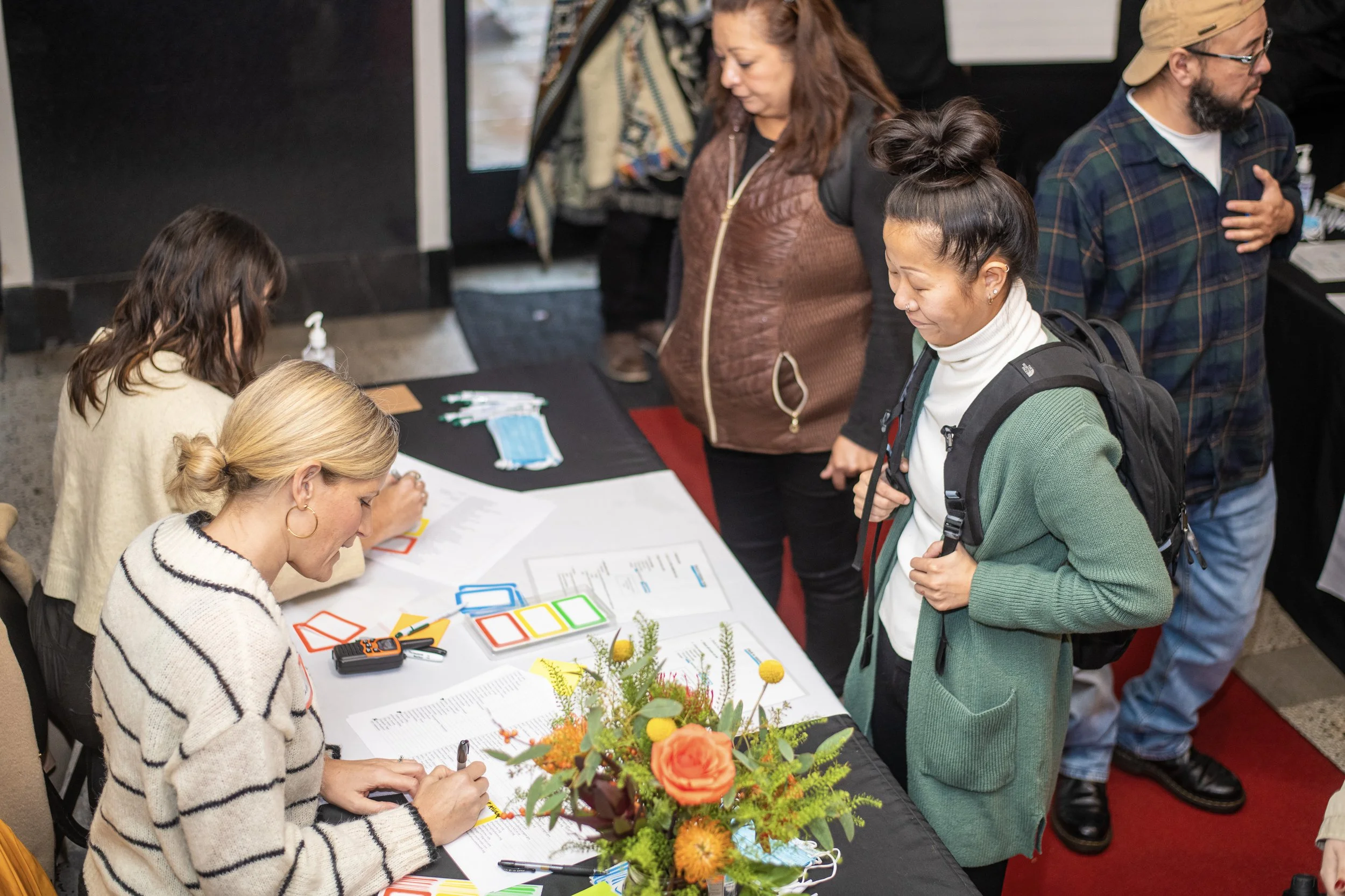  A CSN volunteer checking in attendees at a registration table during a CSN community networking event in Portland, Oregon. 