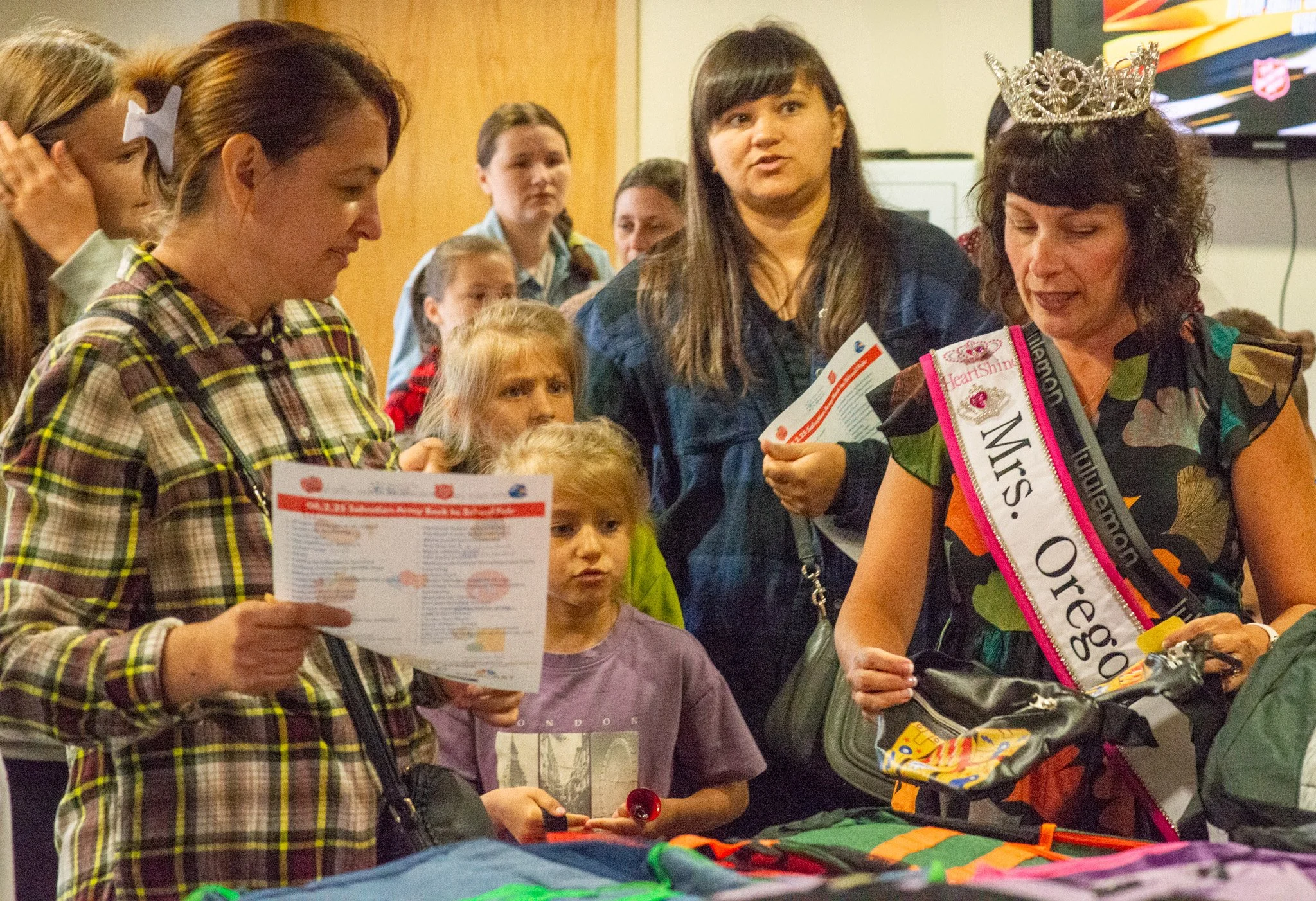  Mrs. Oregon pageant titleholder volunteering and helping distribute backpacks and school supplies to families at a CSN community resource fair in Portland, Oregon. 