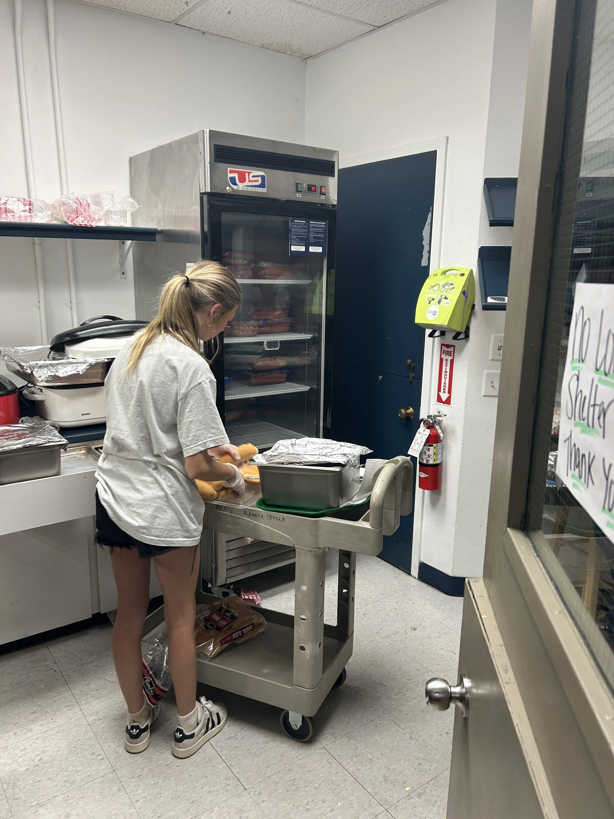  A CSN volunteer preparing and organizing food items in a shelter kitchen during a community service event in Portland, Oregon. 