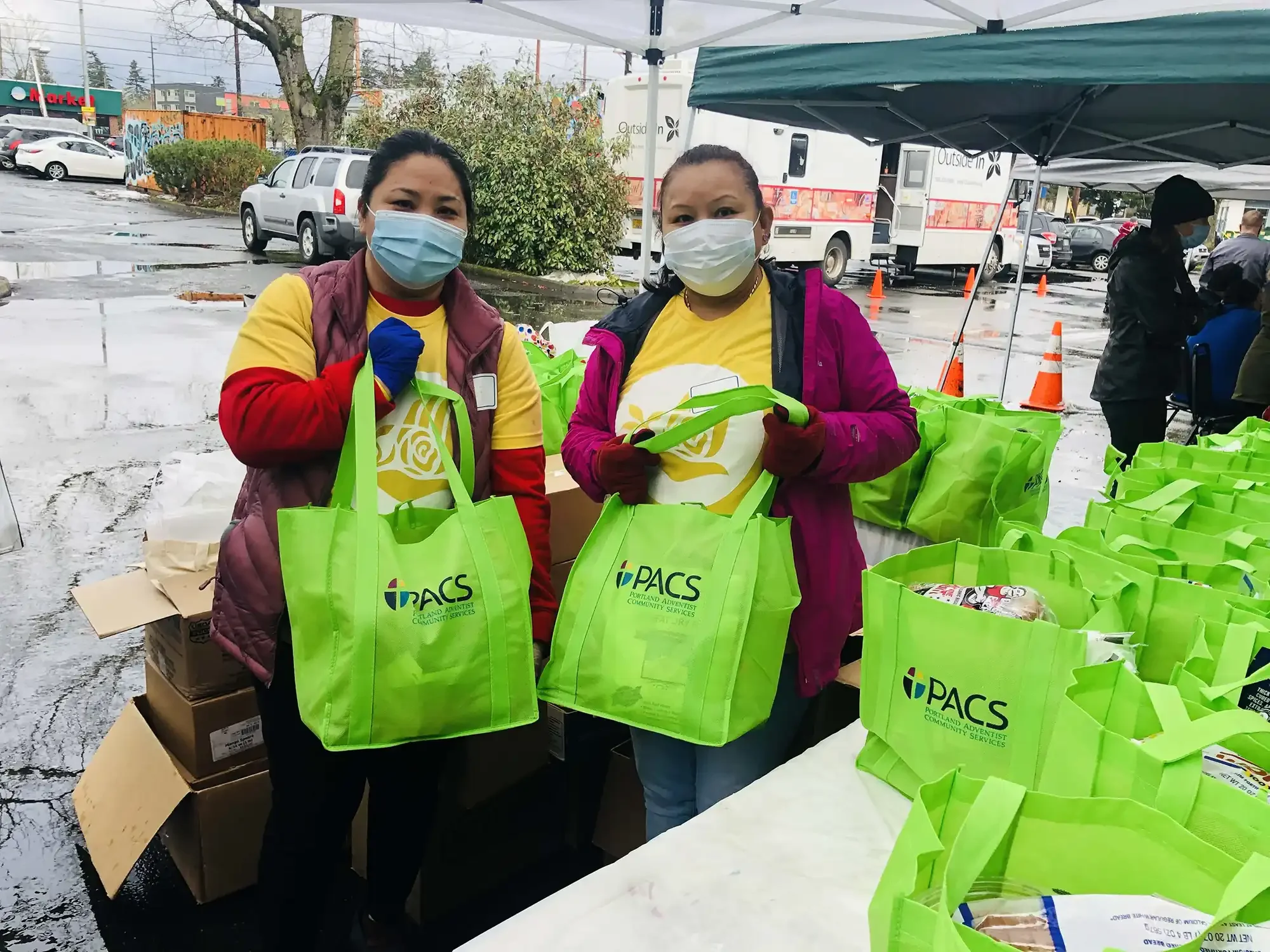 Masked employees handing out food bags