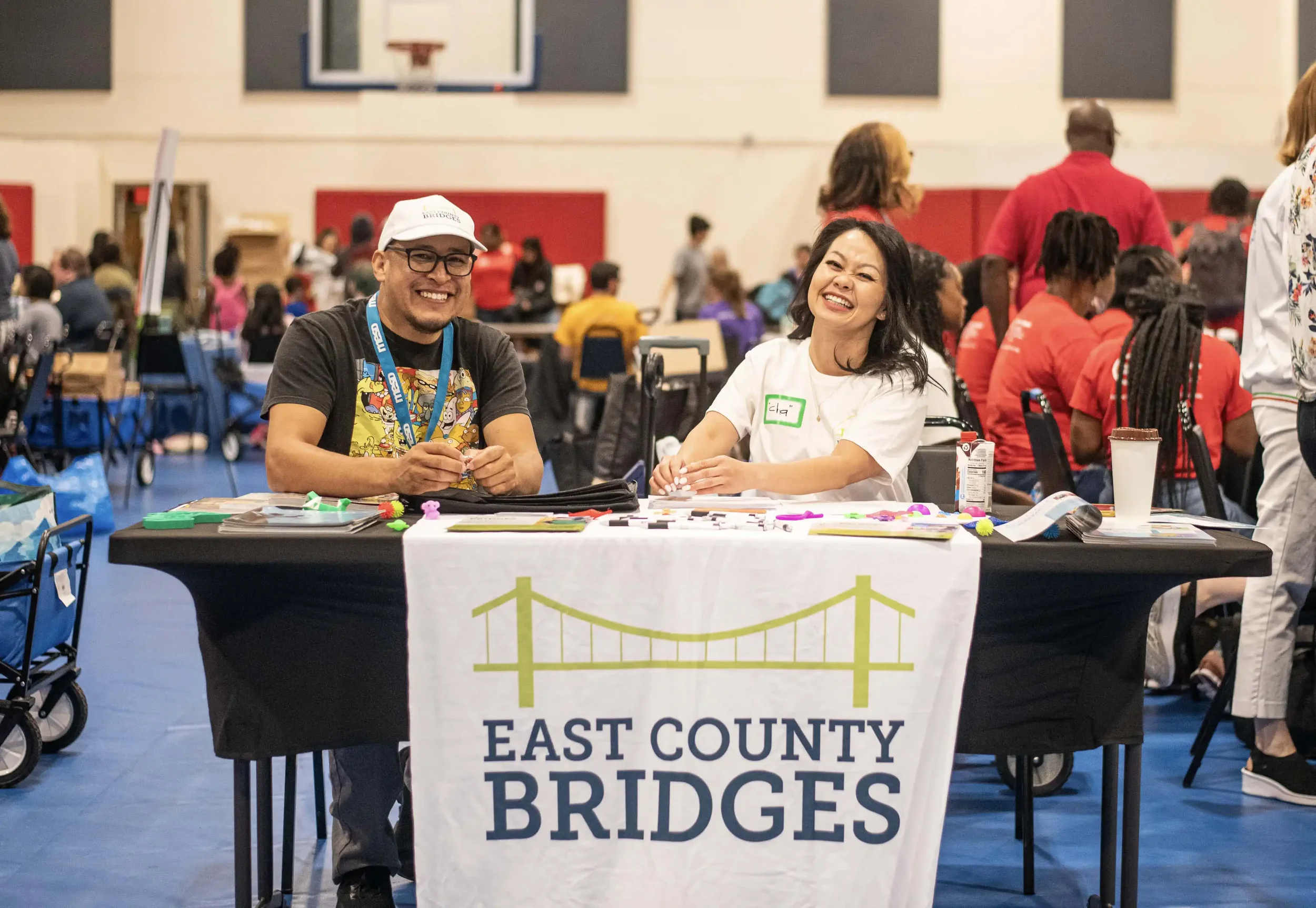 Table with happy East County Bridges employees