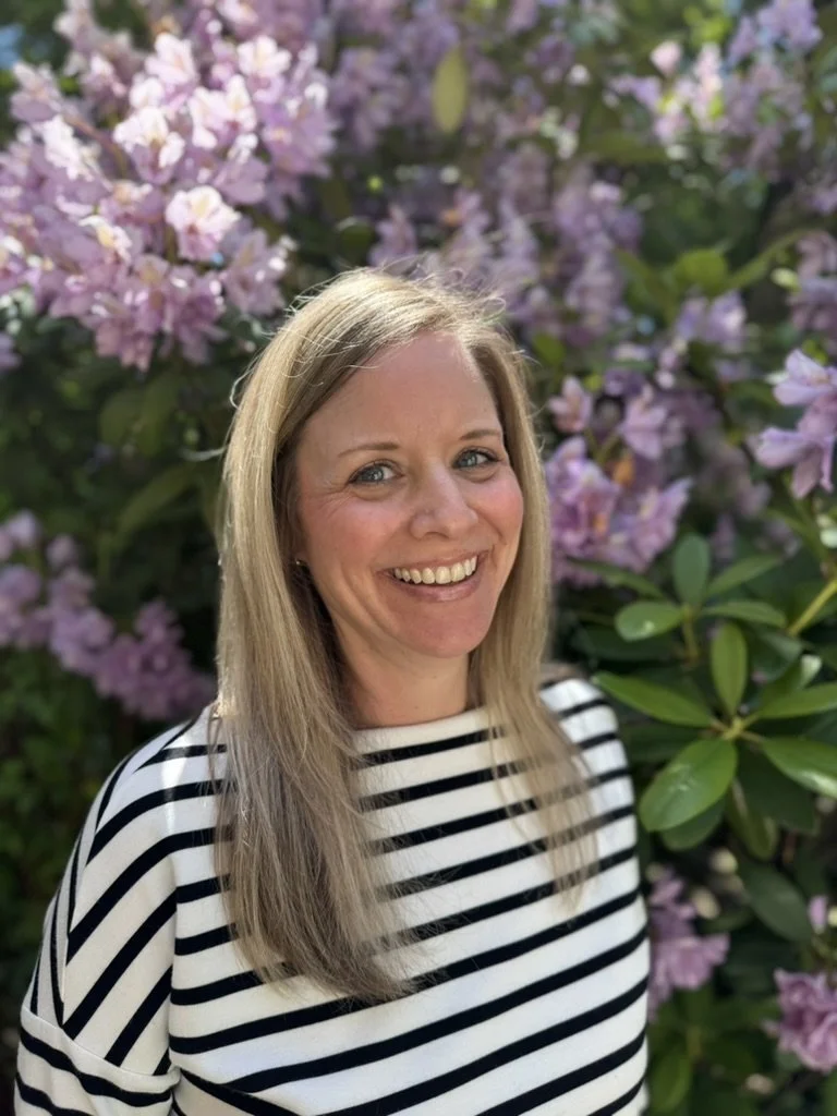 Jamie Dudley, bookkeeper at Free Guitars 4 Kids, smiling in a staff portrait that reflects her support for the mission of sharing music with kids.