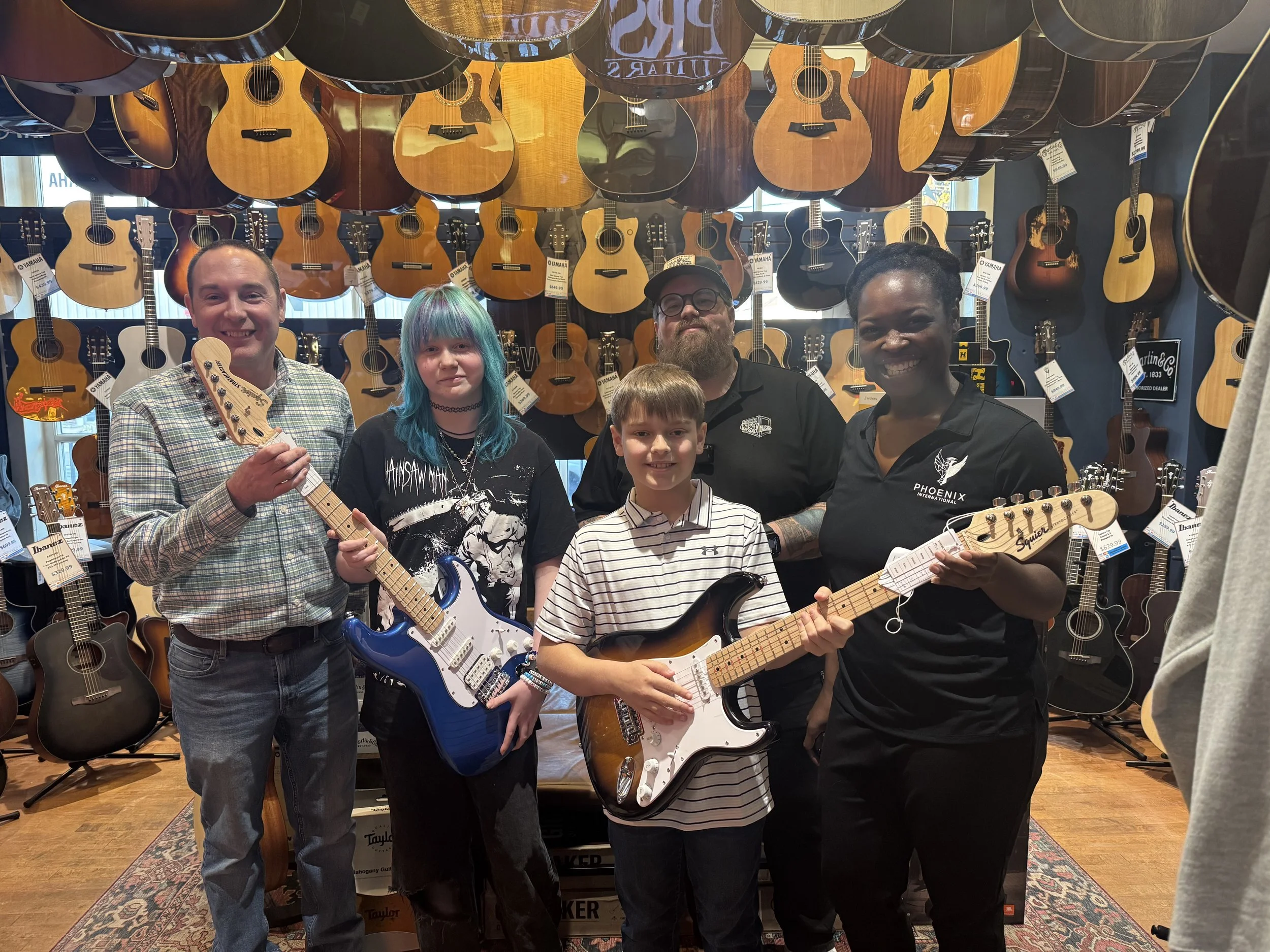 Jackson and Claudia receive new guitars from FG4K, Island Music Co., and PISOTA in La Plata, Maryland.
