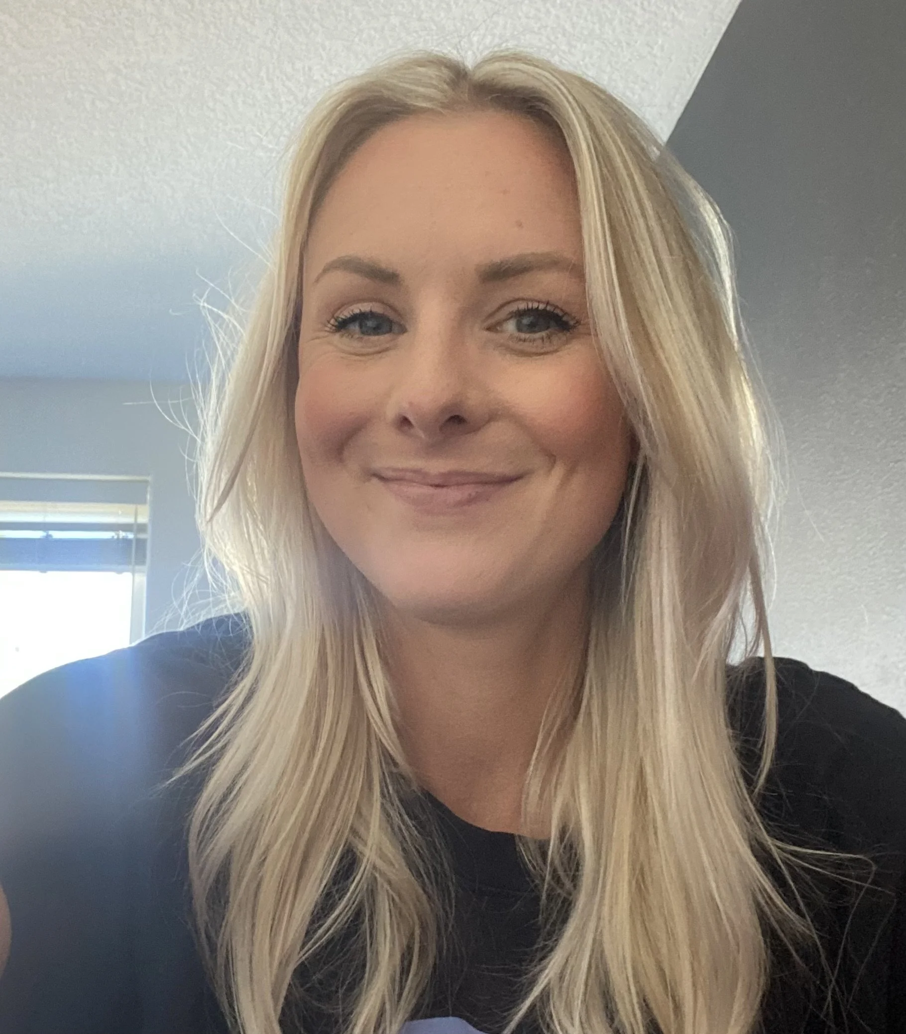 Christina Garber, team member at Free Guitars 4 Kids, smiling in a professional staff portrait celebrating music and community.