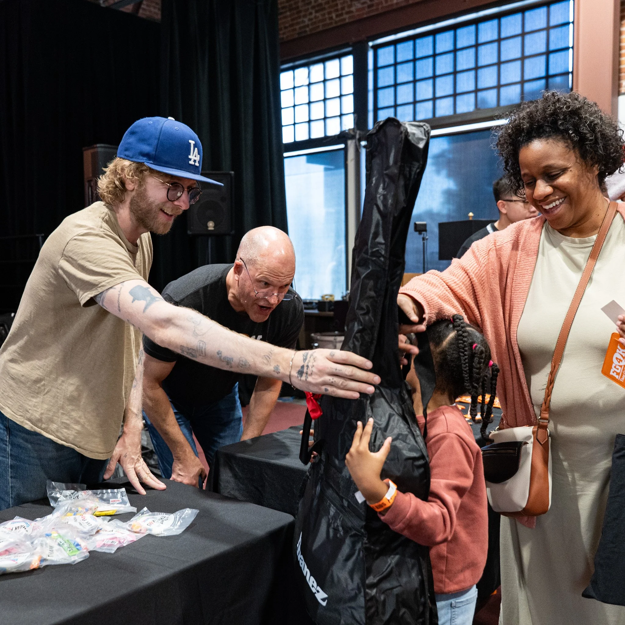 Griffin from Dawes give a guitar to a new guitarist