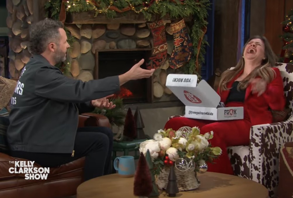 Ben Dudley giving Kelly Clarkson an Air-Guitar