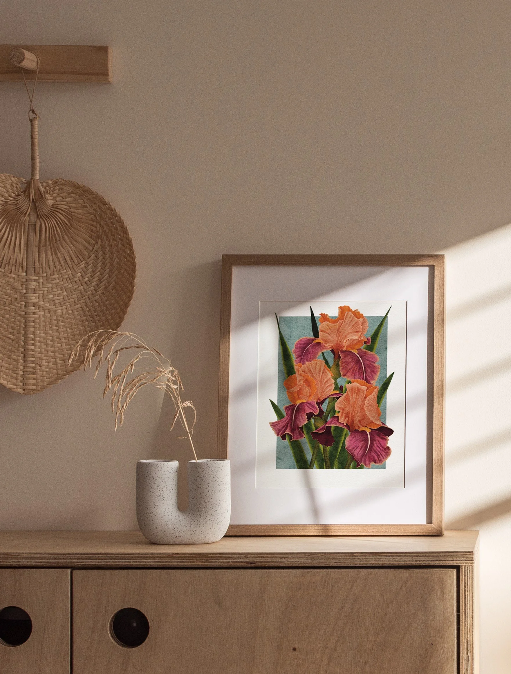 Framed Carnaby Iris fine art print by Liz Govier Art Studio styled on wall above a wooden desk in natural daylight.