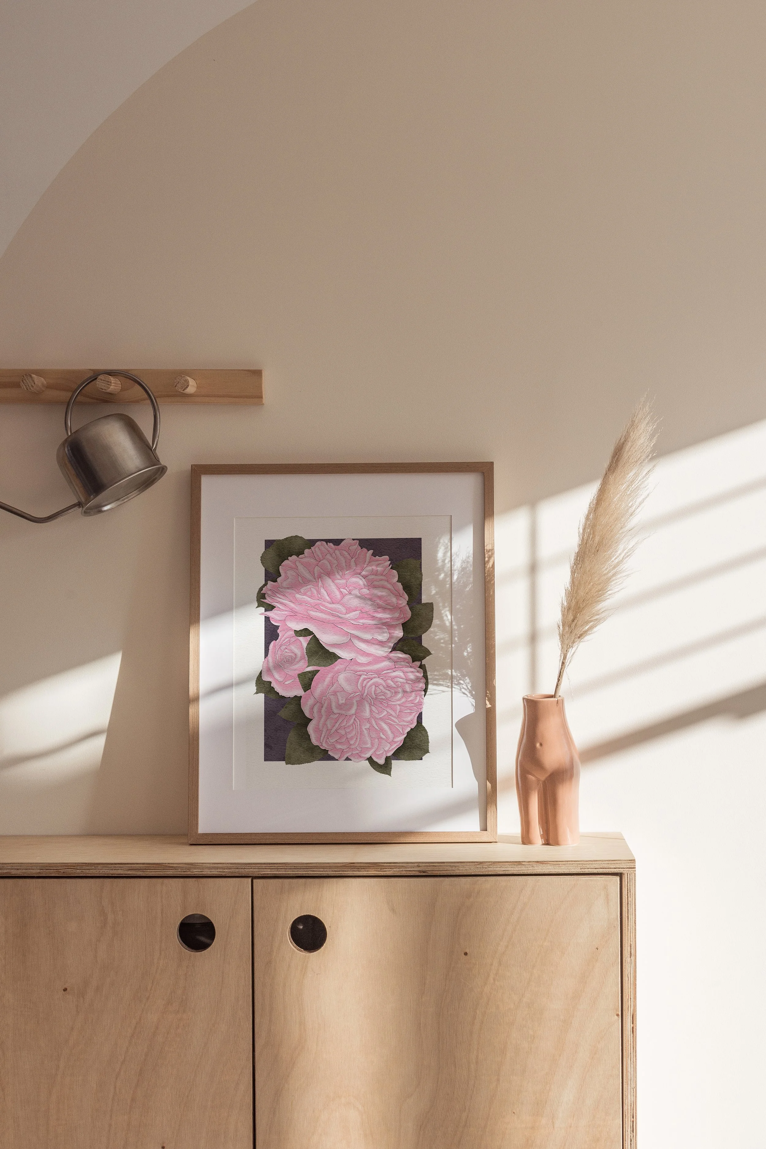 Framed Pink Roses fine art print by Liz Govier Studio on a wooden sideboard with dried pampas and warm sunlight.