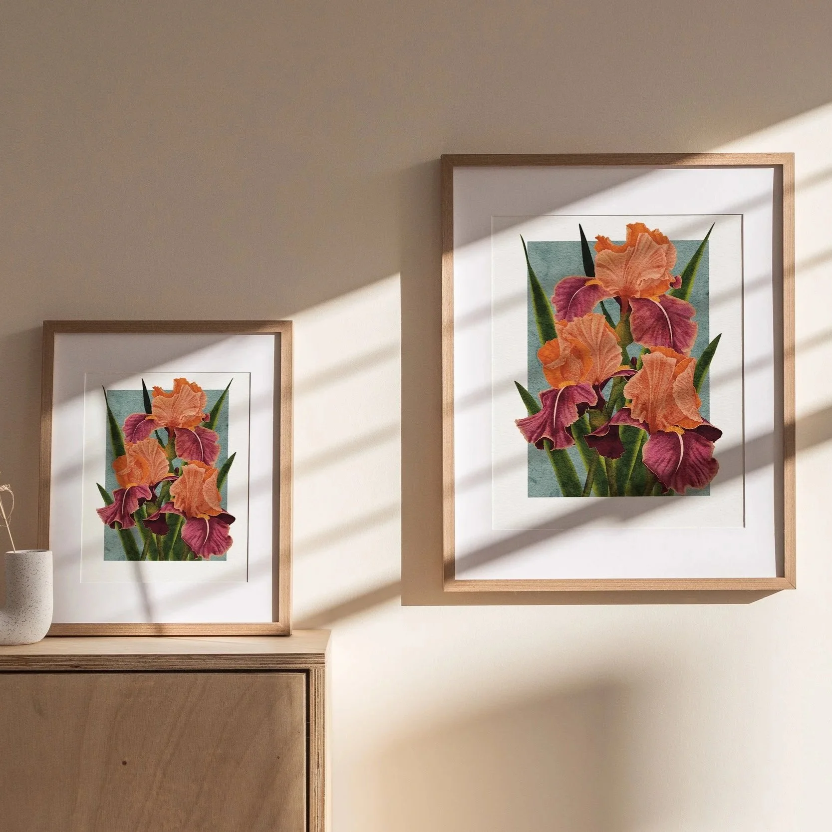 Framed Carnaby Iris art print displayed on a wooden cabinet in warm sunlight, botanical wall art by Liz Govier Art Studio.
