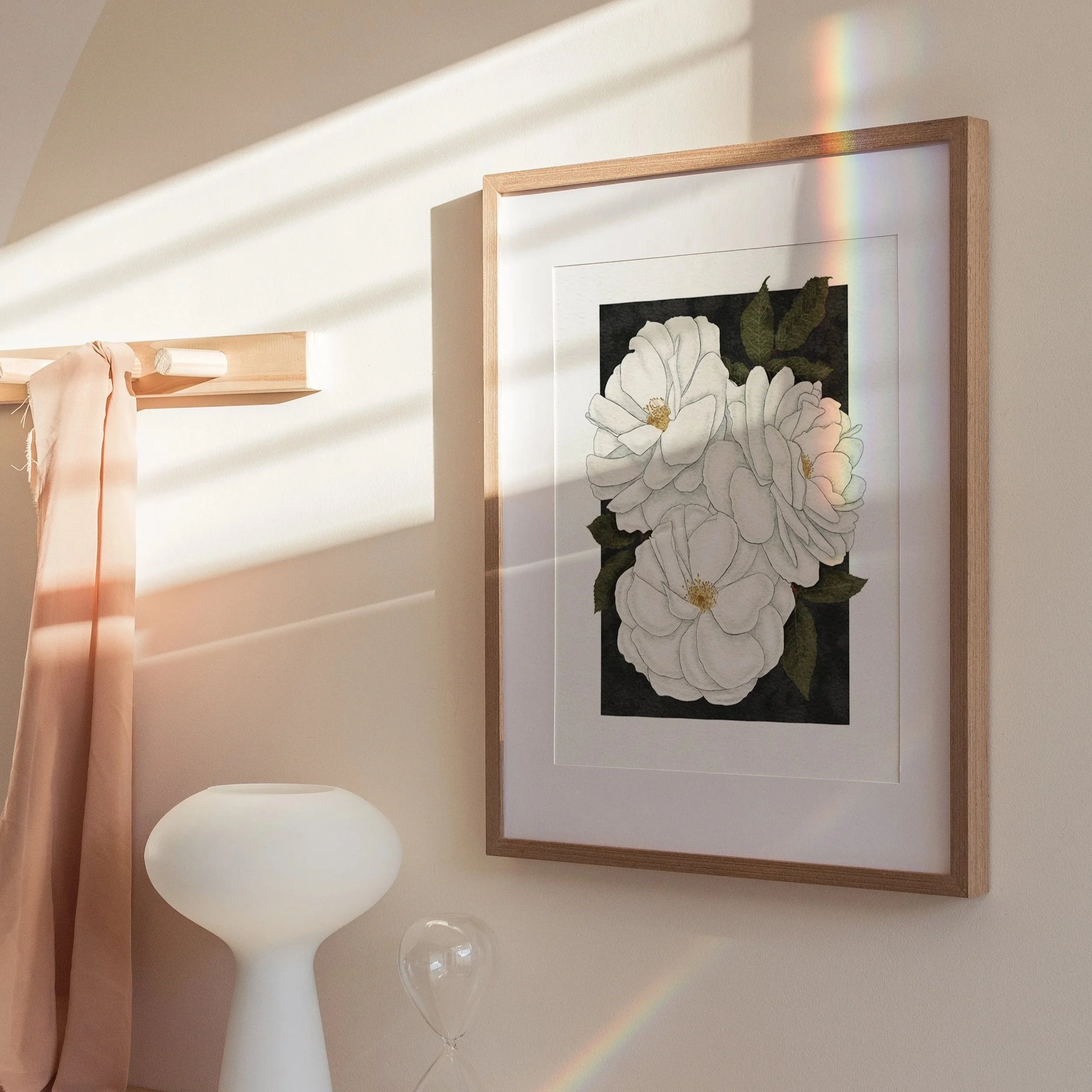 Madame Alfred Carrière roses art print displayed on a wall with soft sunlight and natural styling, framed botanical wall décor by Liz Govier Art Studio.