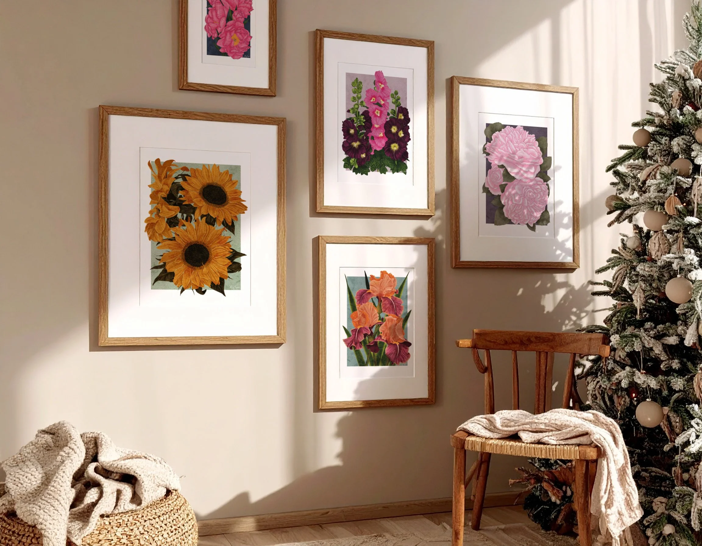 A collection of framed fine art botanical prints by Liz Govier Studio displayed beside a natural Christmas tree, styled for a calm and timeless winter interior.
