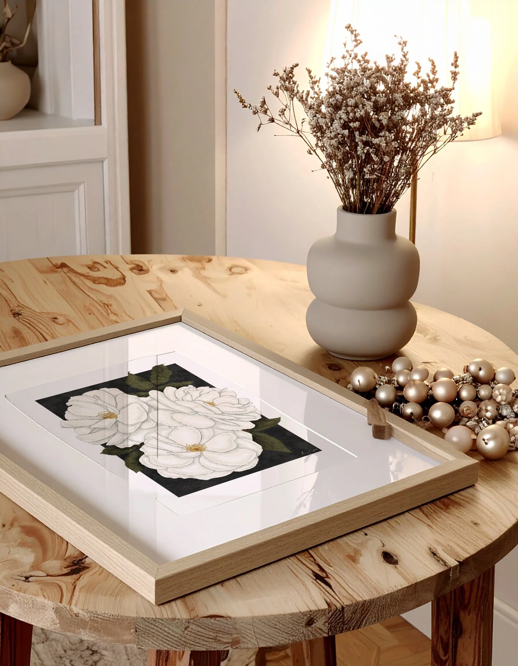 Framed Madame Alfred Carrière fine art print on a wooden table with soft light and dried flowers, styled for winter interiors.