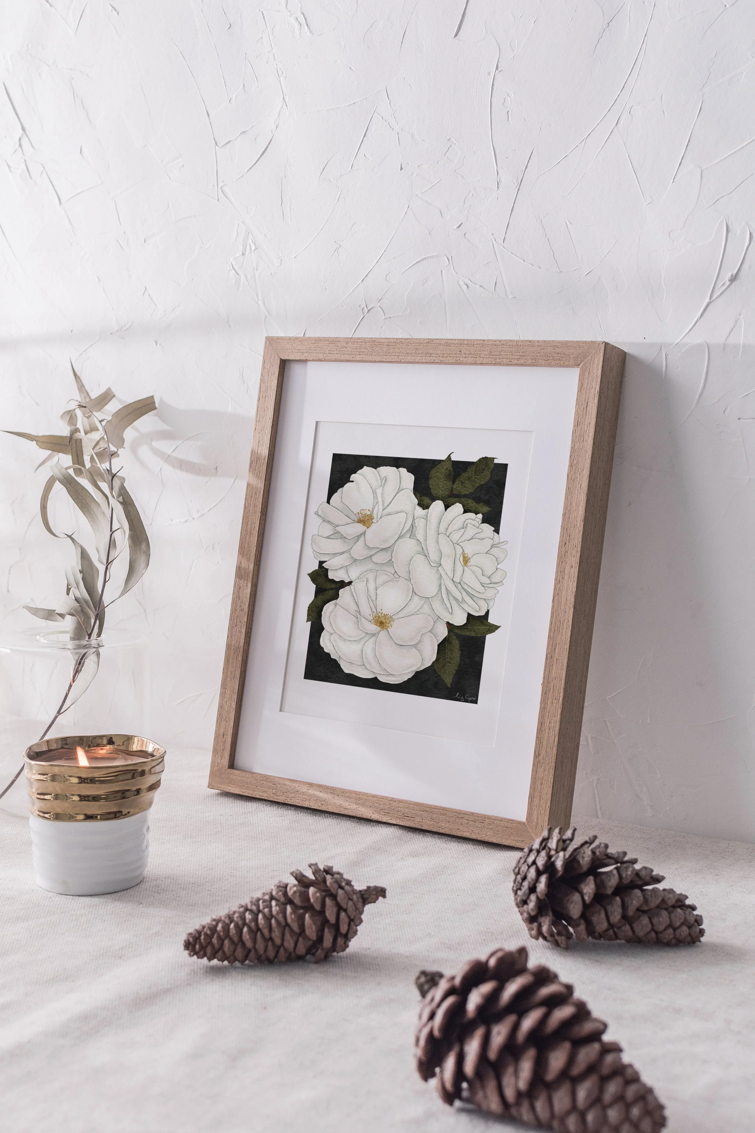 Madame Alfred Carrière fine art print by Liz Govier Studio, styled for Christmas with dried leaves, pinecones, and candlelight.