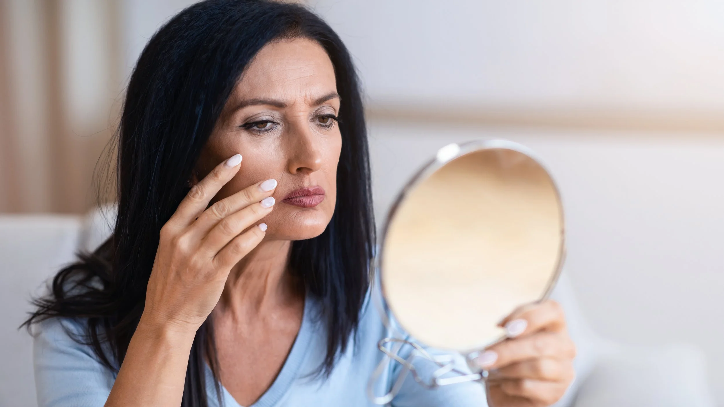 Midlife woman noticing changes that may accompany hormonal changes and perimenopause