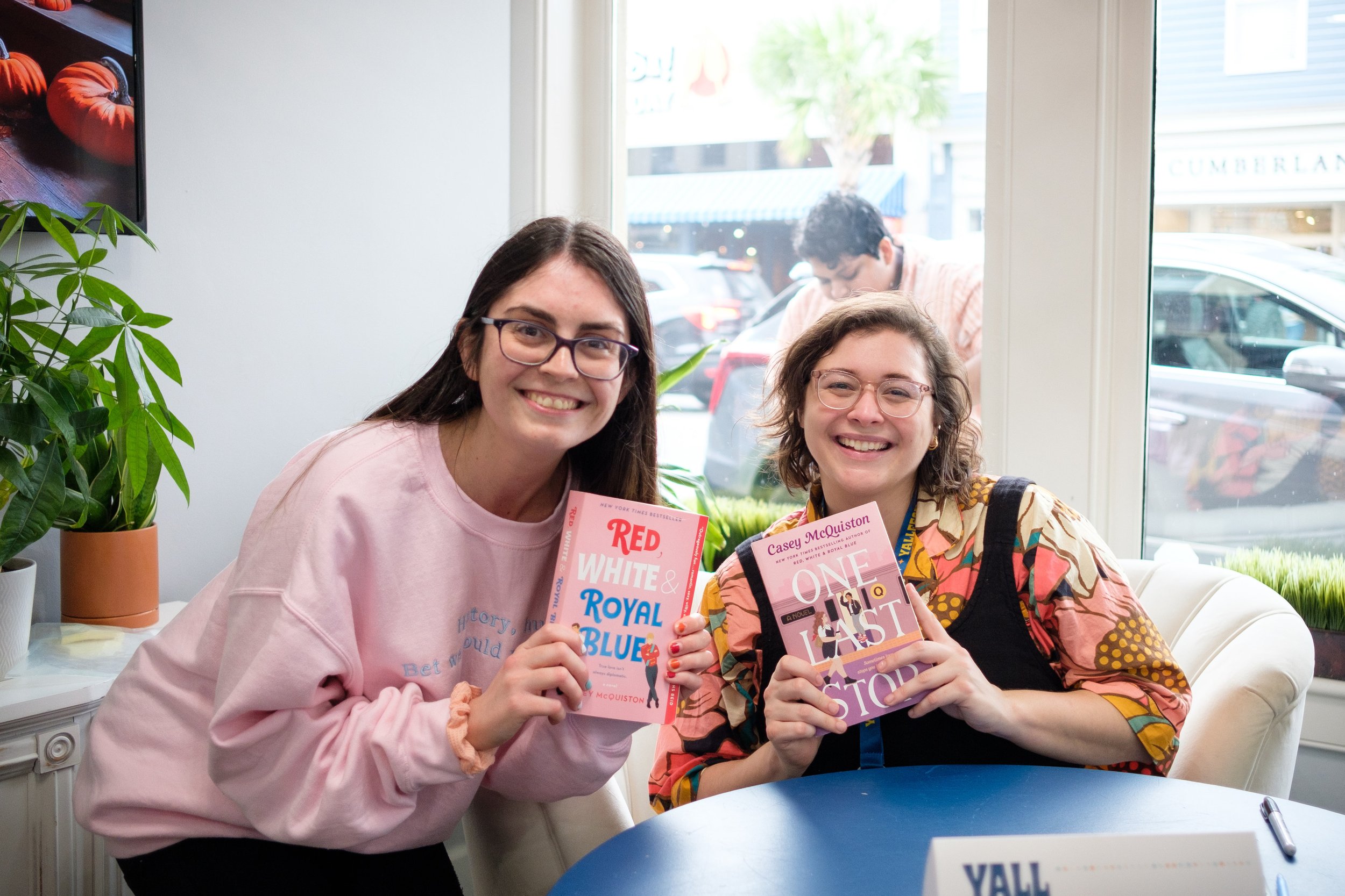 Author Casey McQuiston poses with a fan