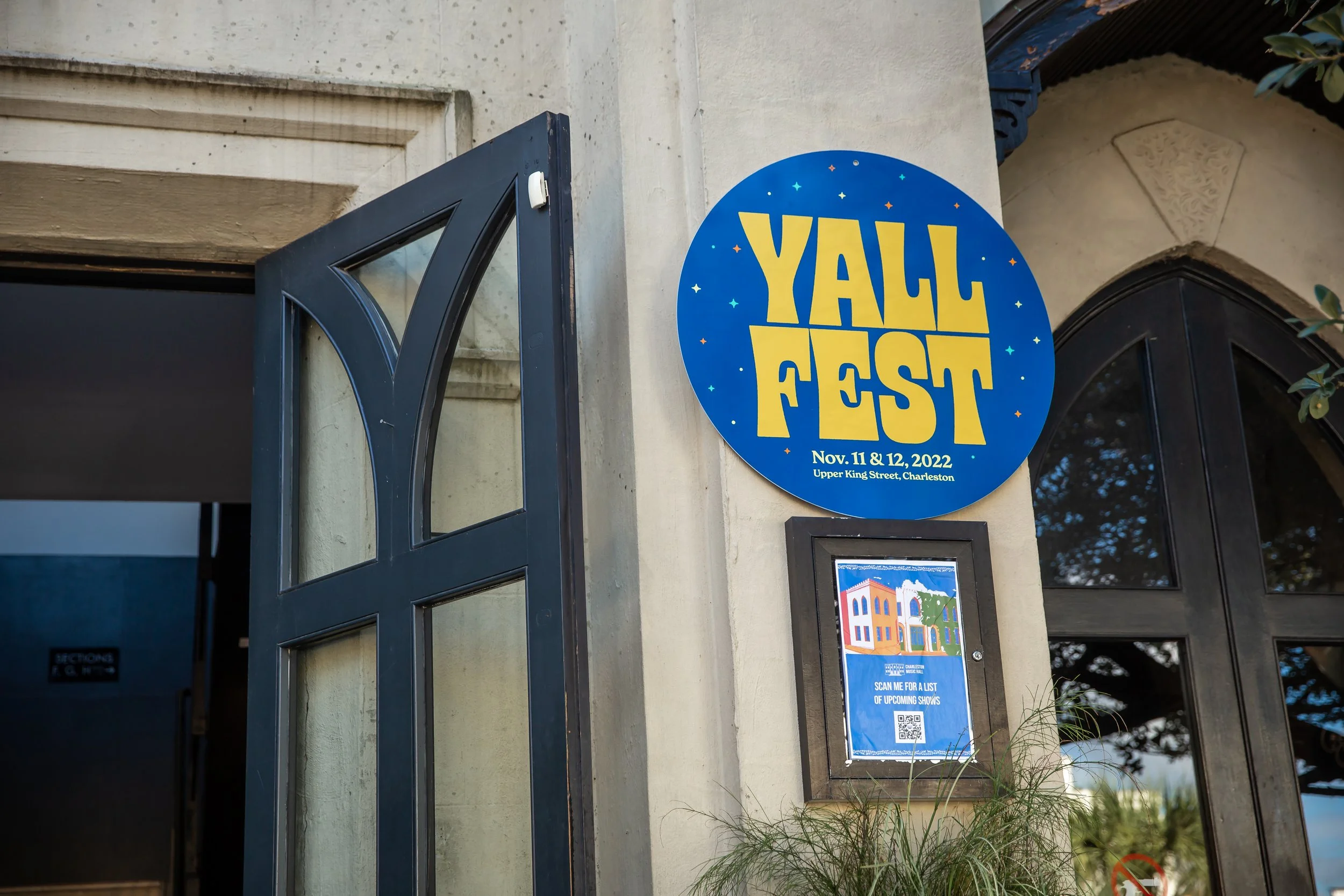 a circular YALLFEST sign outside of the Charleston Music Hall