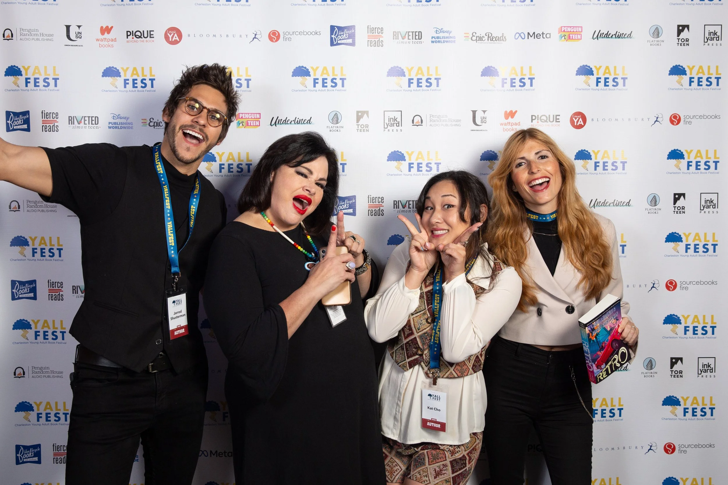 Authors  Jarrod Shusterman, Angeline Boulley, Kat Cho, and Sofia Lapuente pose in front of the step and repeat