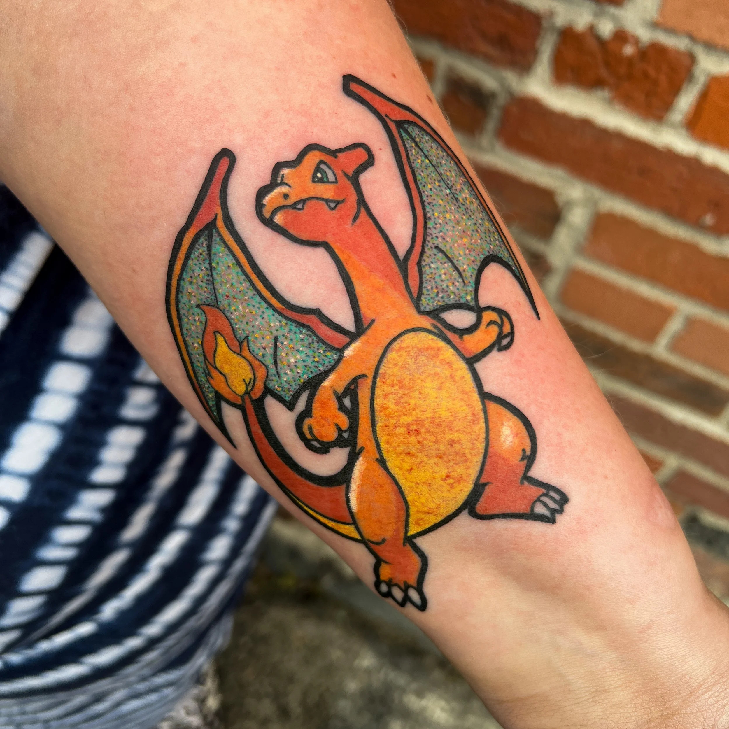 Charizard arm tattoo