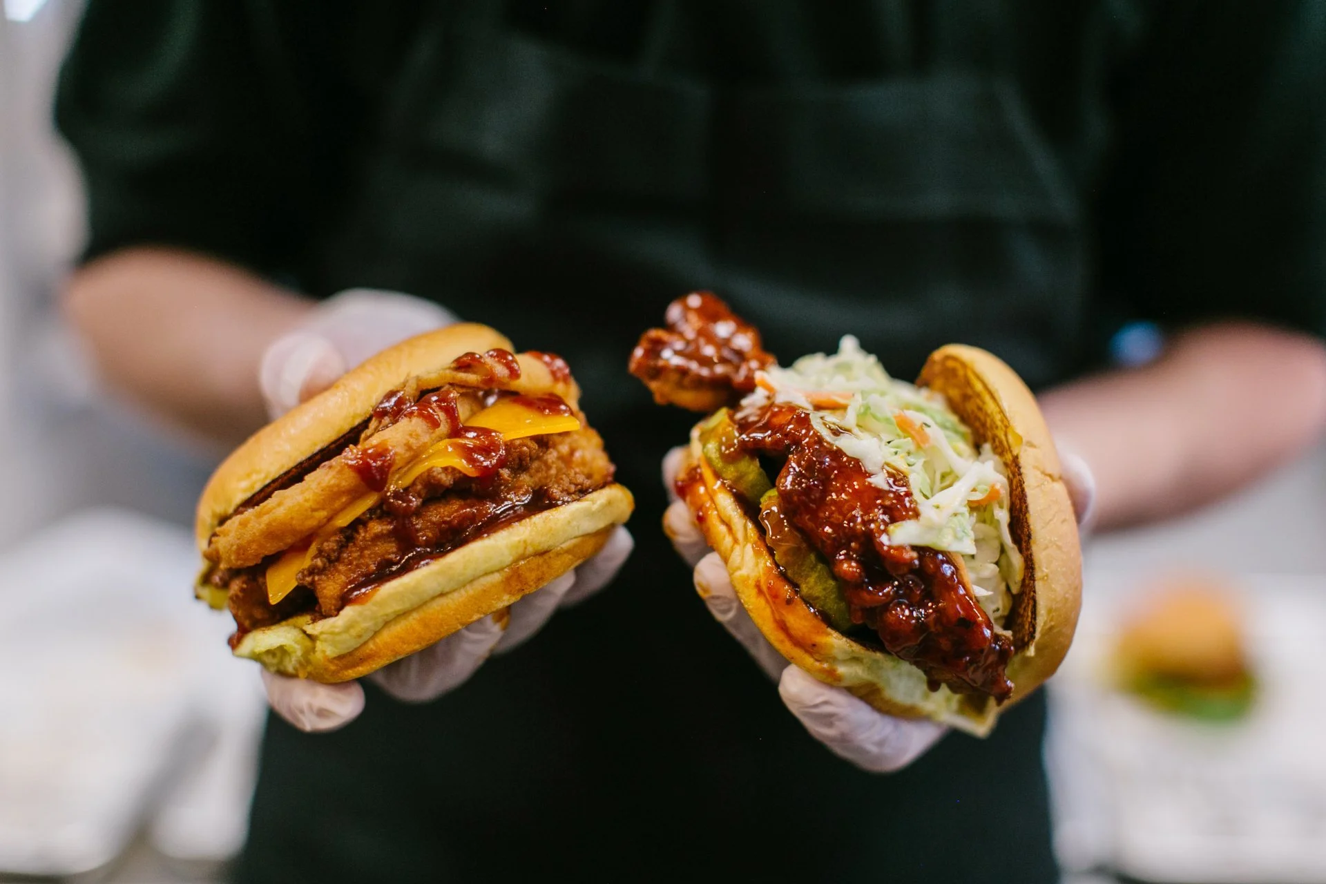 holding 2 sandwwiches.jpeg