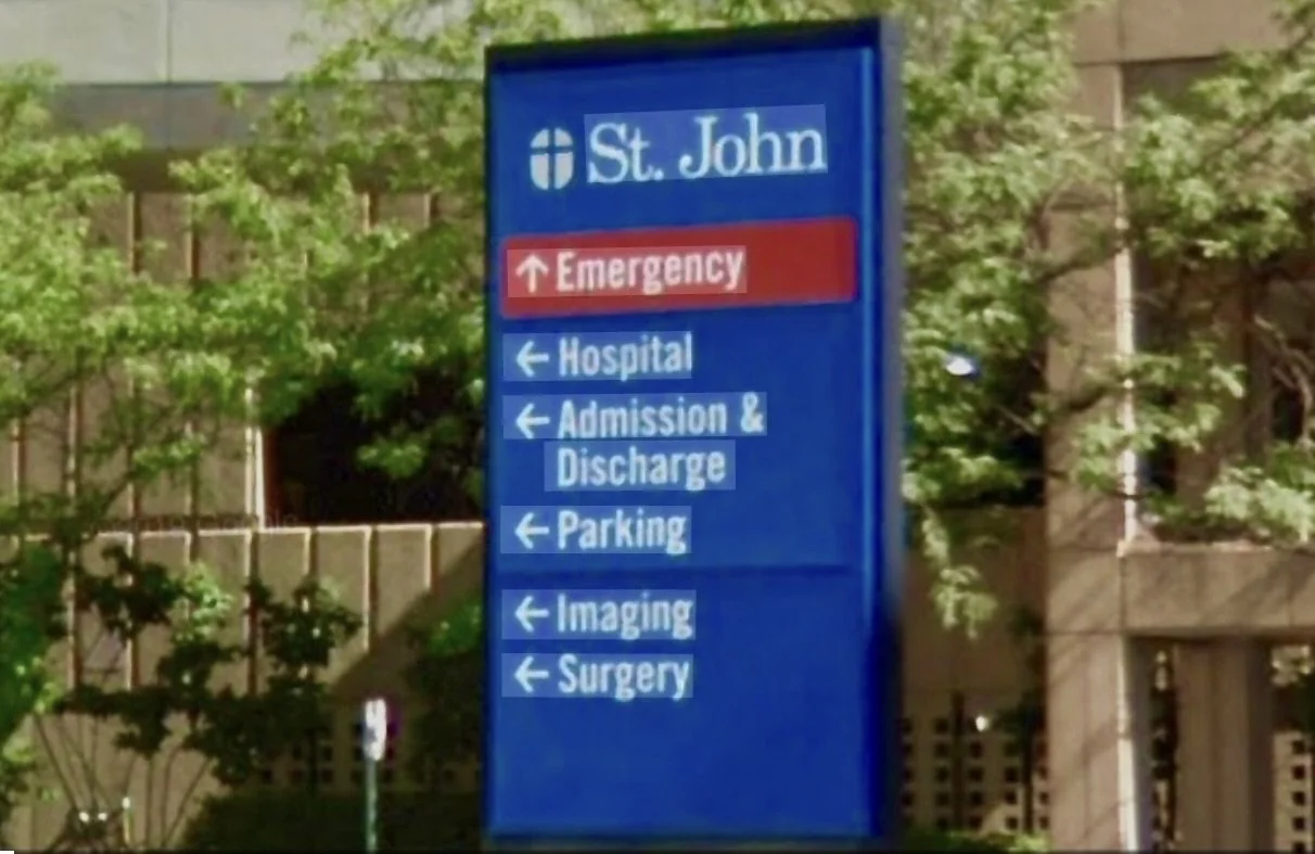 Hospital directory sign at St. John hospital with directions for emergency, hospital, admission and discharge, parking, imaging, and surgery.