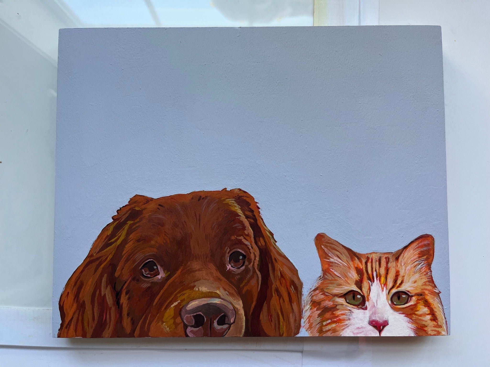 Painting of a brown dog with long ears and a fluffy orange and white cat, both positioned at the bottom of the canvas, against a light blue background.