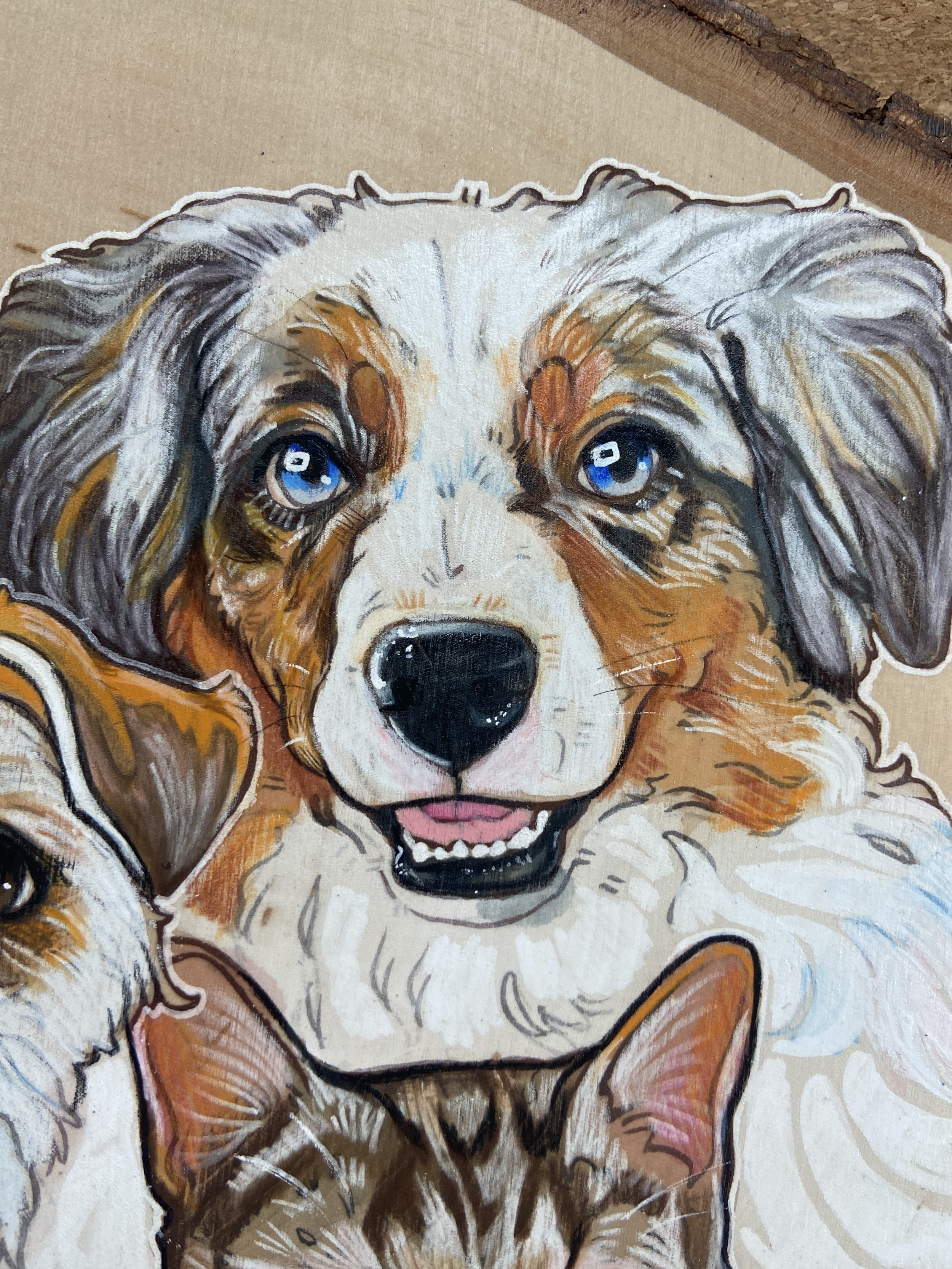 A colorful painted illustration of a happy Australian Shepherd puppy with blue eyes, accompanied by a partially visible small dog and cat.