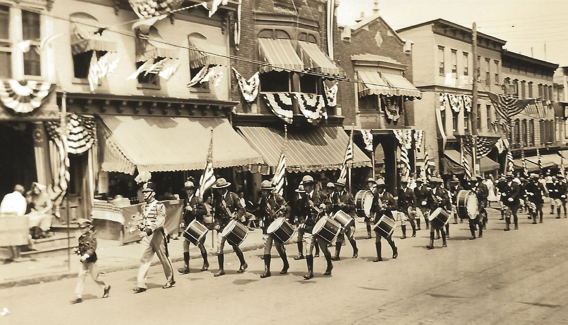 Drum Major and Drum Line of Marching Band in Parade on Sunbury St. circa 1920
