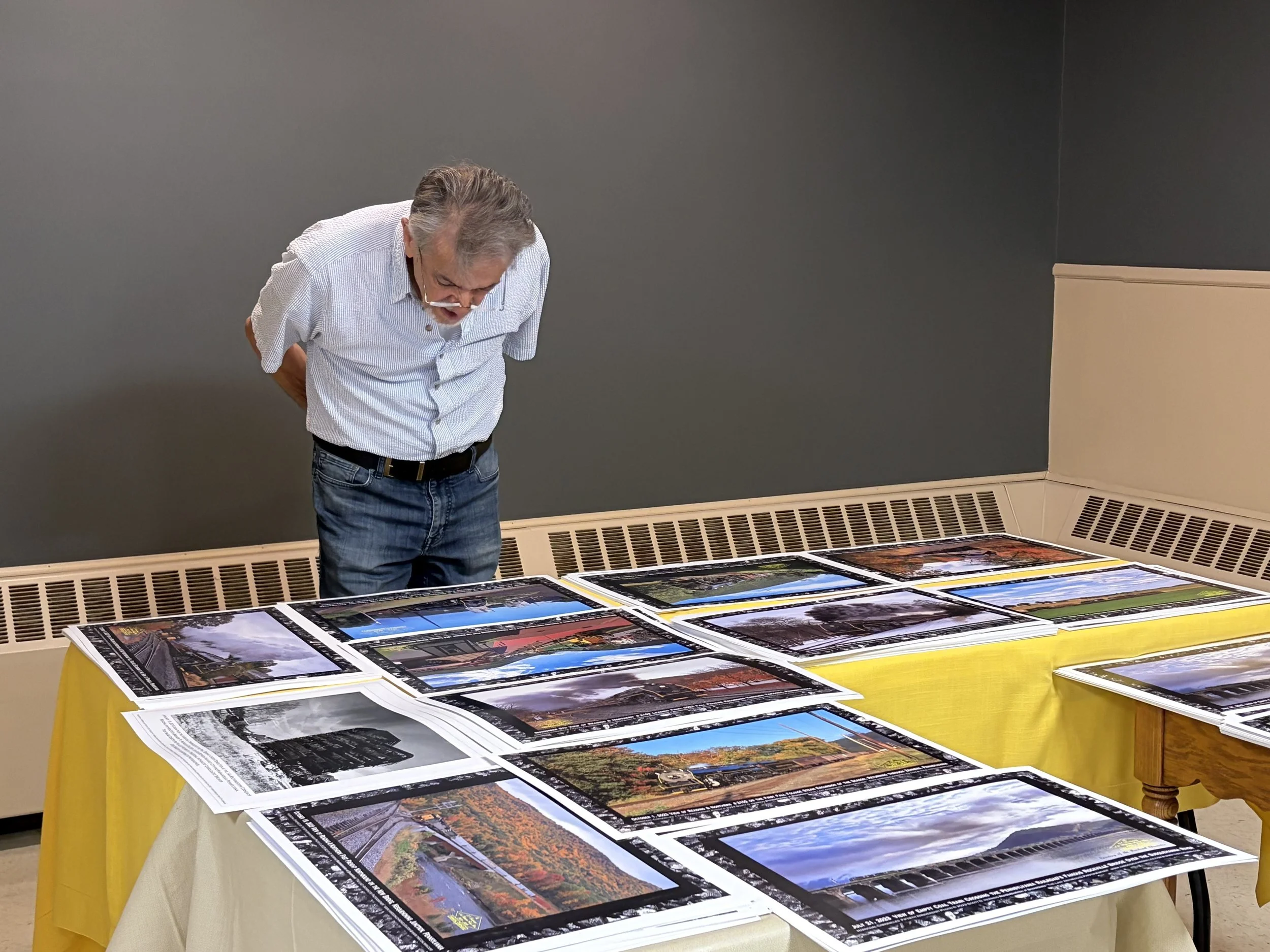Fred Phillips browses the train posters for sale.