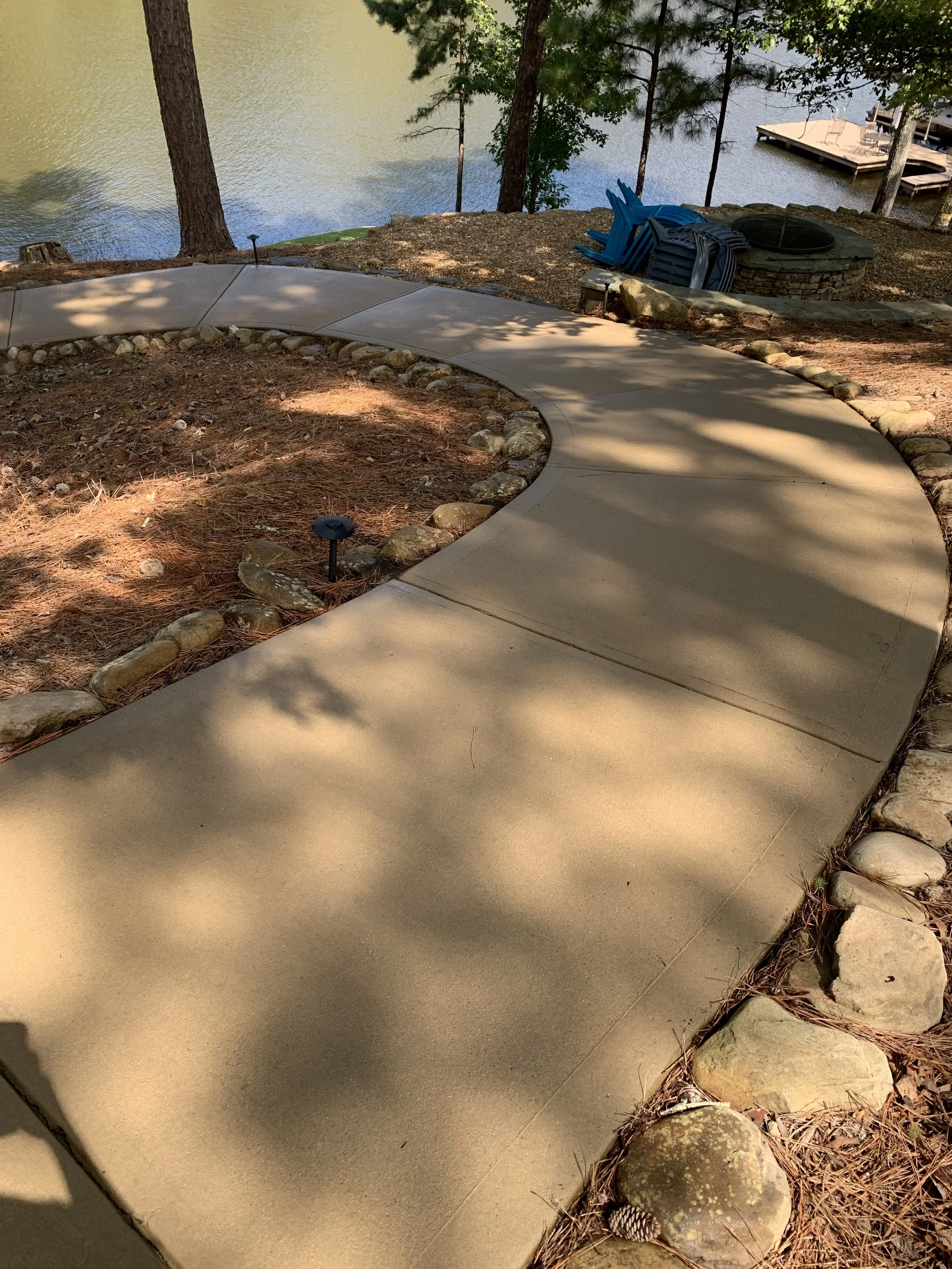 Pressure washing a concrete driveway at a residential property in Greensboro, GA
