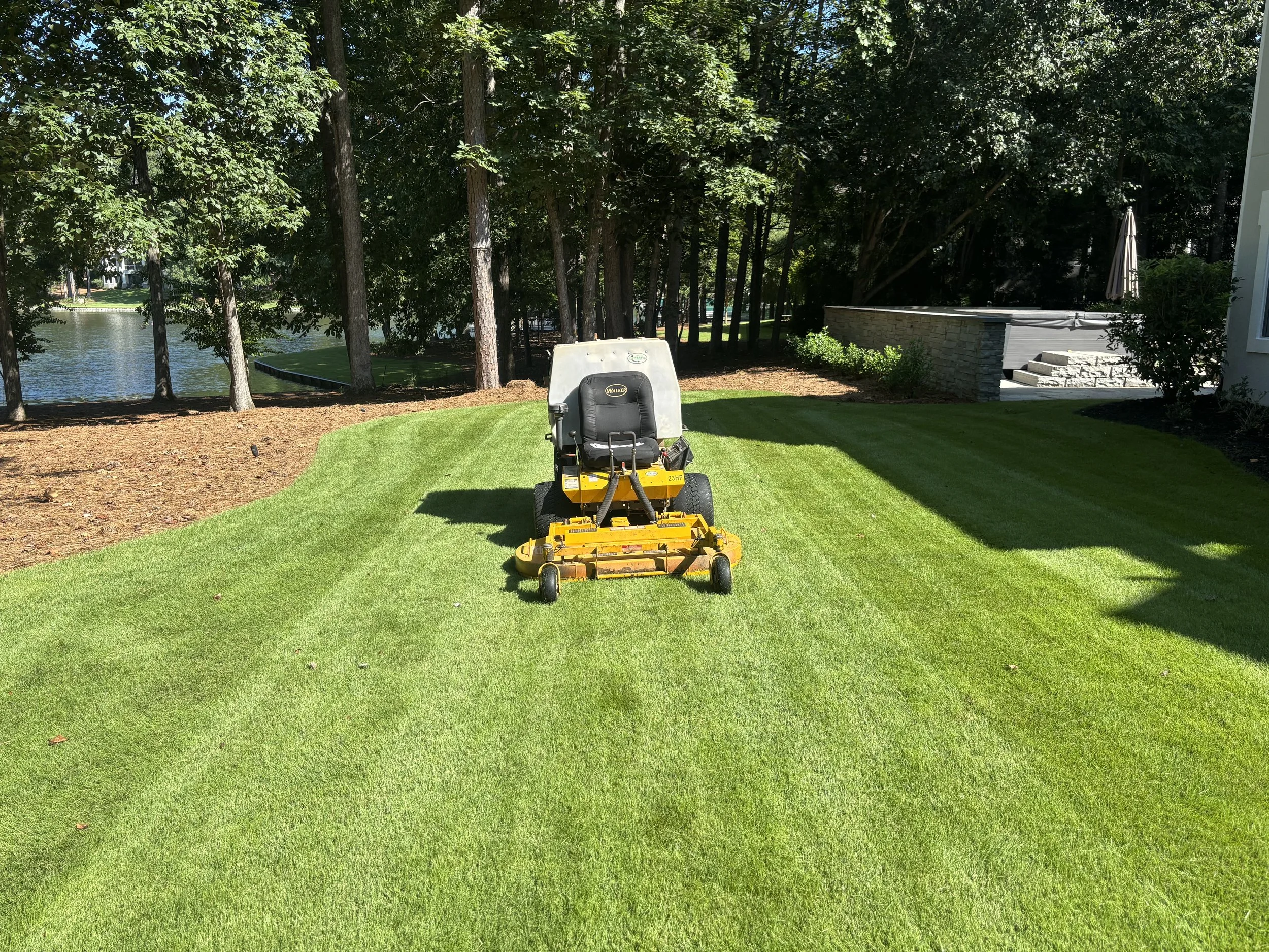 Professional lawn maintenance and mowing service at a residential home in Lake Oconee, Georgia