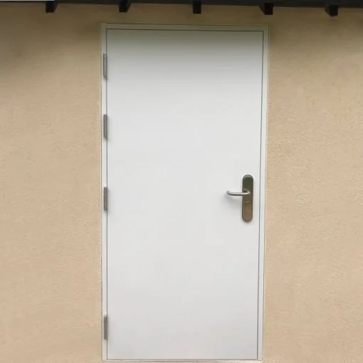 A plain white door with metallic hinges and handle, set in a beige wall with a dark wooden overhang above.