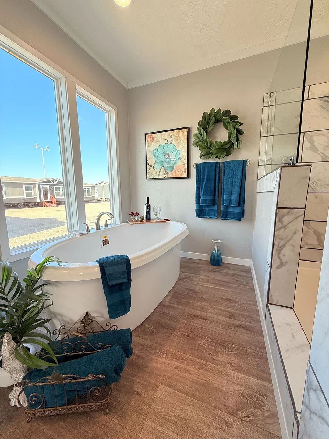 Spacious tub next to a large window in a modern bathroom, mobile home