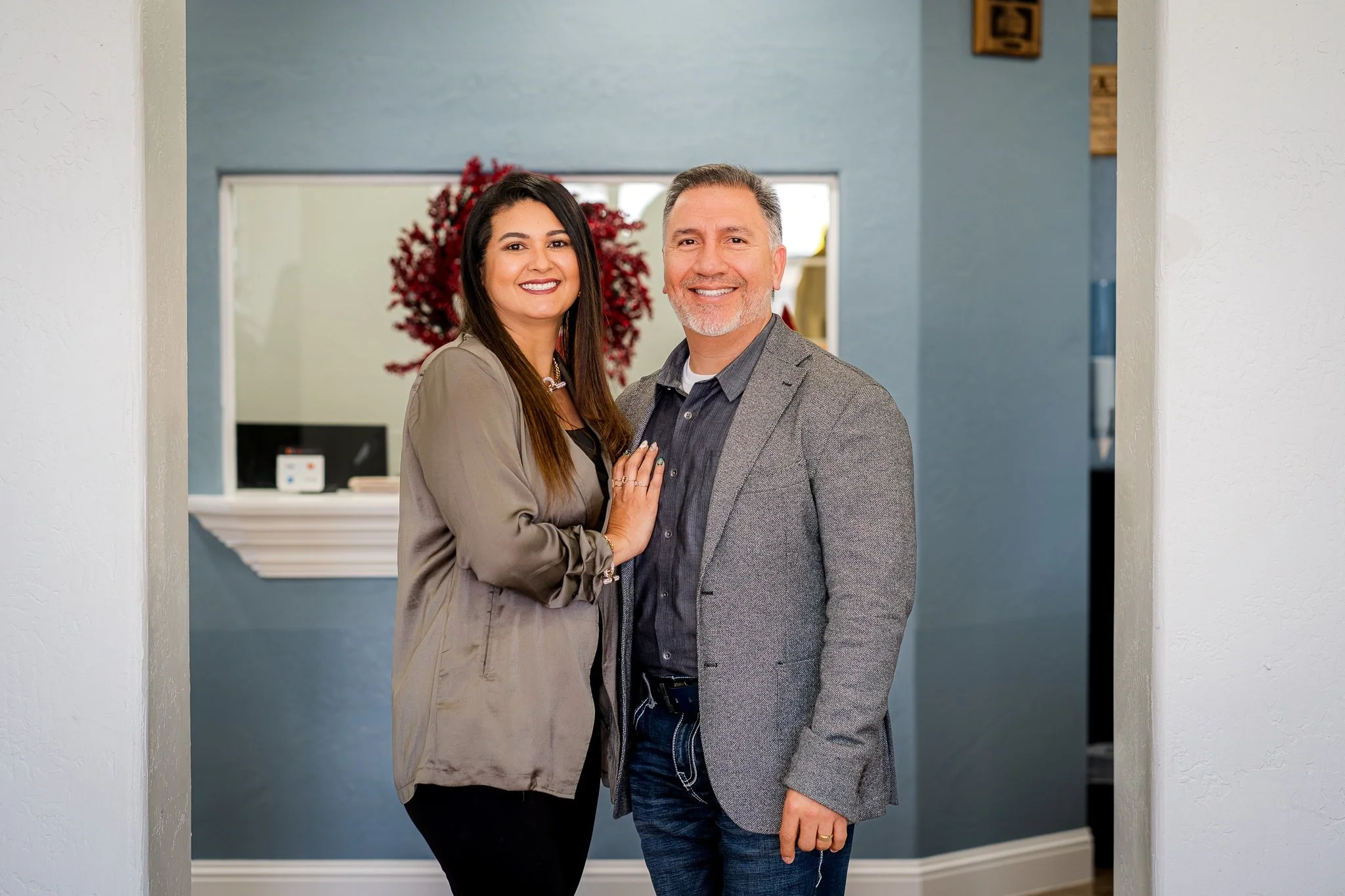 Fiesta Homes owners stand in their business office available to take scheduling appointments