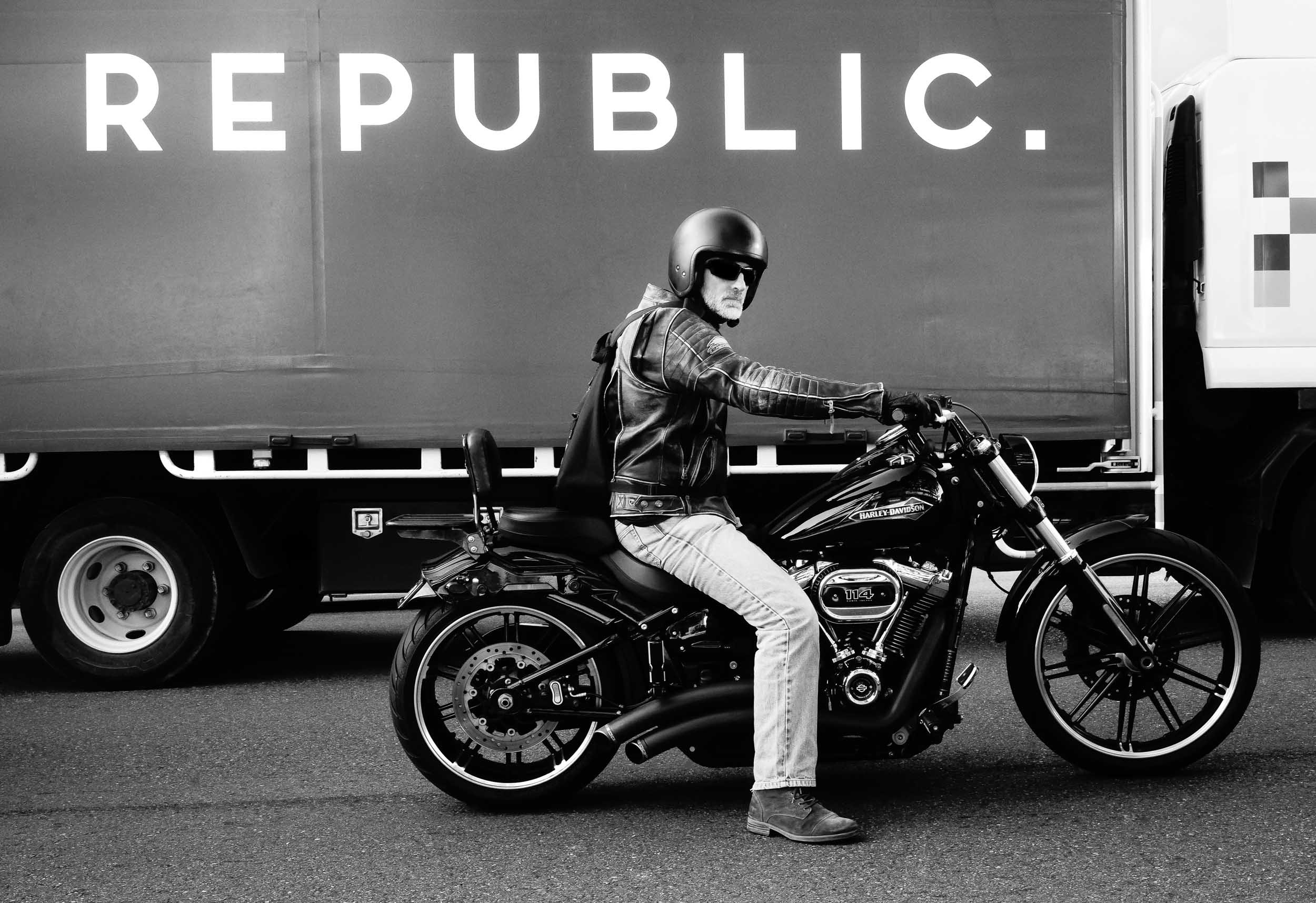 Unseen Connections: In life's grand, complex machinery, a lone rider's reflection emerges. Even beside towering giants, we subtly navigate our distinct paths, discovering profound peace in personal freedom within the broader, visual human republic.