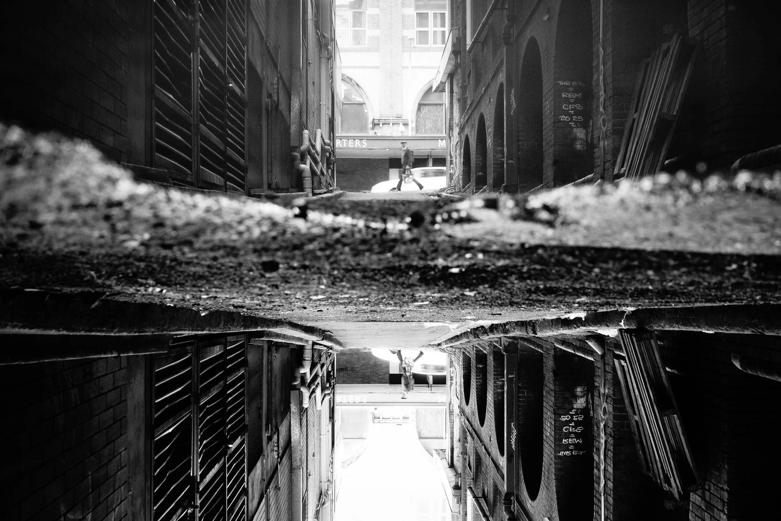 Echoes in the Alley: From life's unassuming depths, profound reflections emerge in unexpected places. Even within shadowed corners, compelling movement beautifully persists, a sad reminder that our journey endures, even amidst the most visceral urban