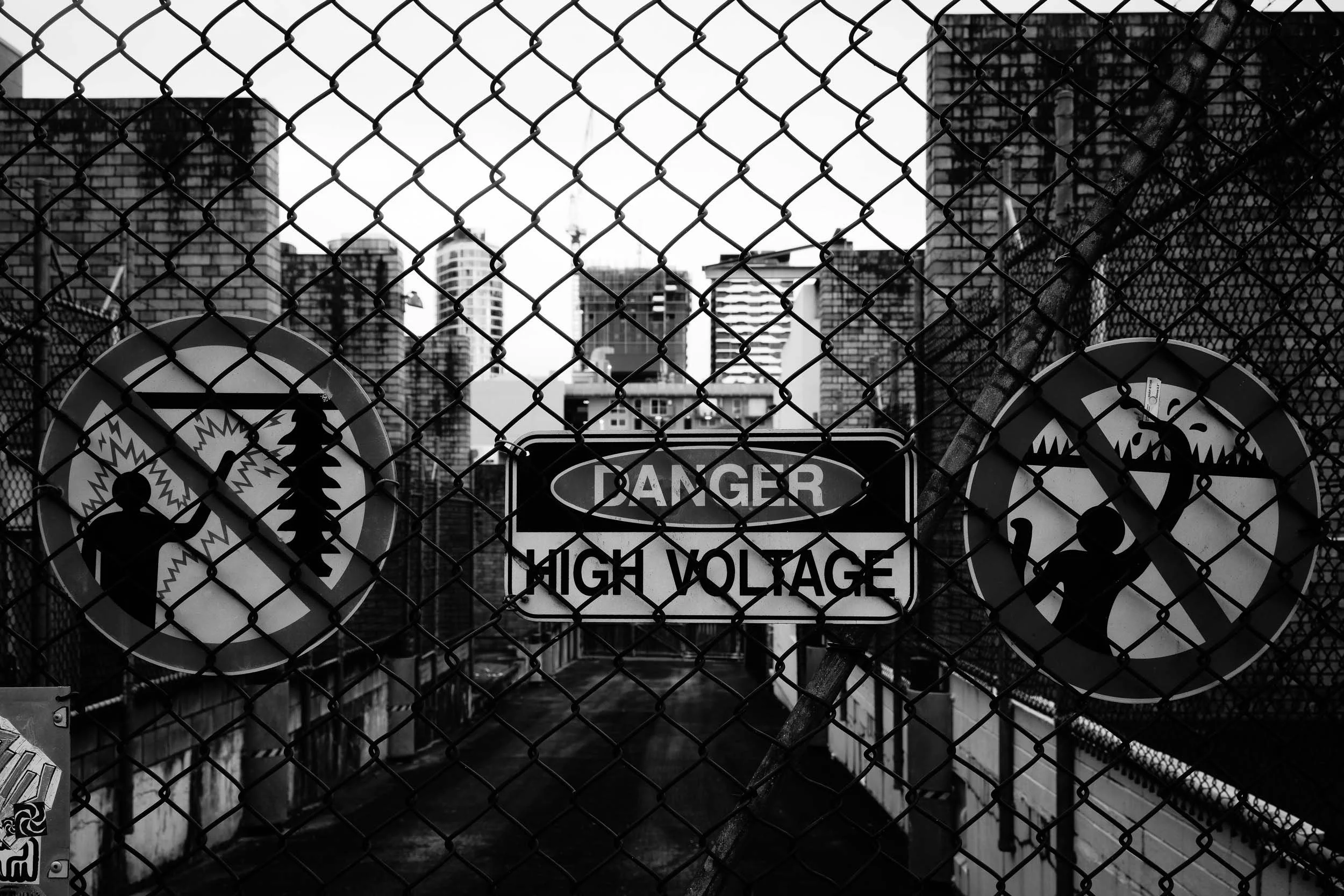 Navigating Life's Currents: Life often presents its "high voltage" warnings. Visually acknowledge these potent dangers, profoundly protect your inner peace, and remember the city's vastness eternally reminds us of the boundless paths that exist beyon