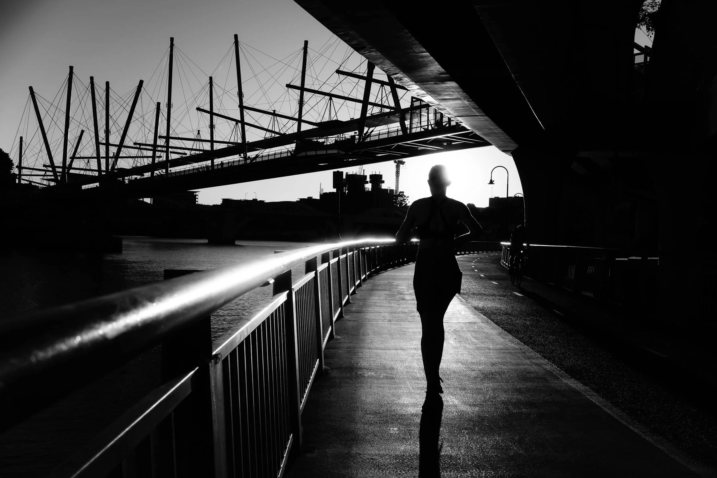 Embracing the Horizon: With every deliberate stride into the setting sun's profound glow, she embraces the day's gentle, reflective close. Within this peaceful movement, reveals a vital truth: each journey, and every ending, holds an enduring new pro