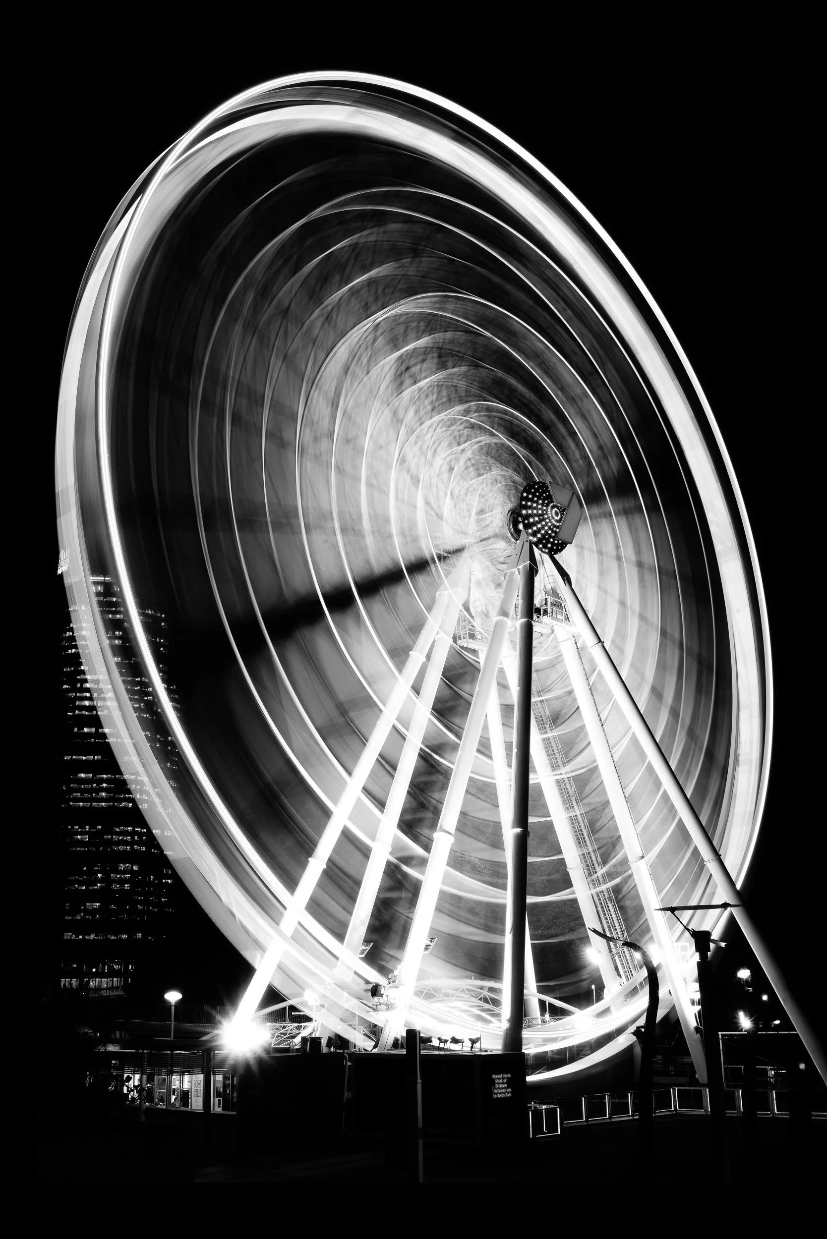 Cycles of Light: Life's journey, an exquisite, evocative blur of motion. The Ferris wheel stands as a timeless reminder: every spin, every cycle of luminous light and profound dark, is part of an ongoing and hopeful narrative.