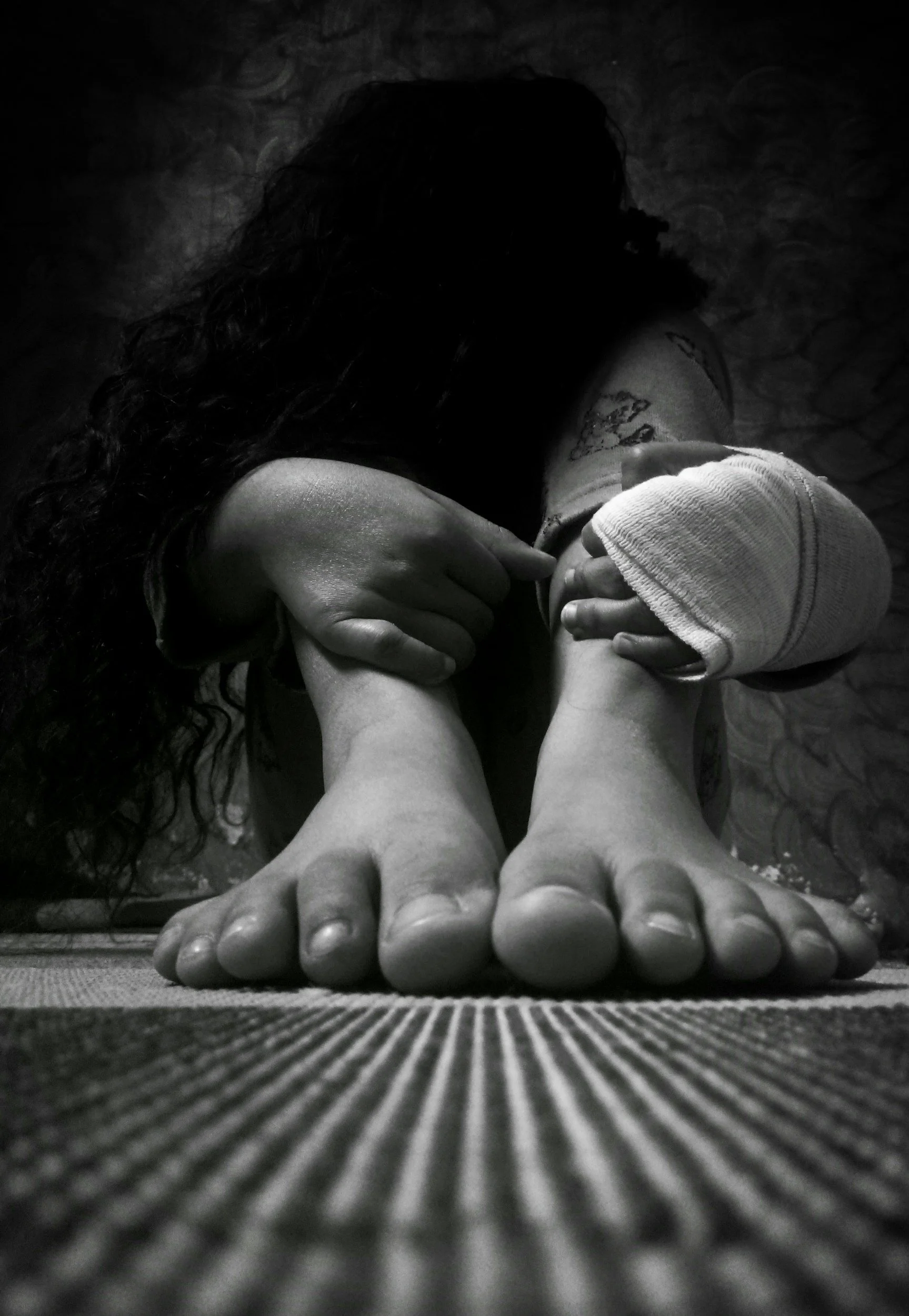 A glowing light bulb shaped like a heart with a filament inside, emitting a warm yellow-orange light.