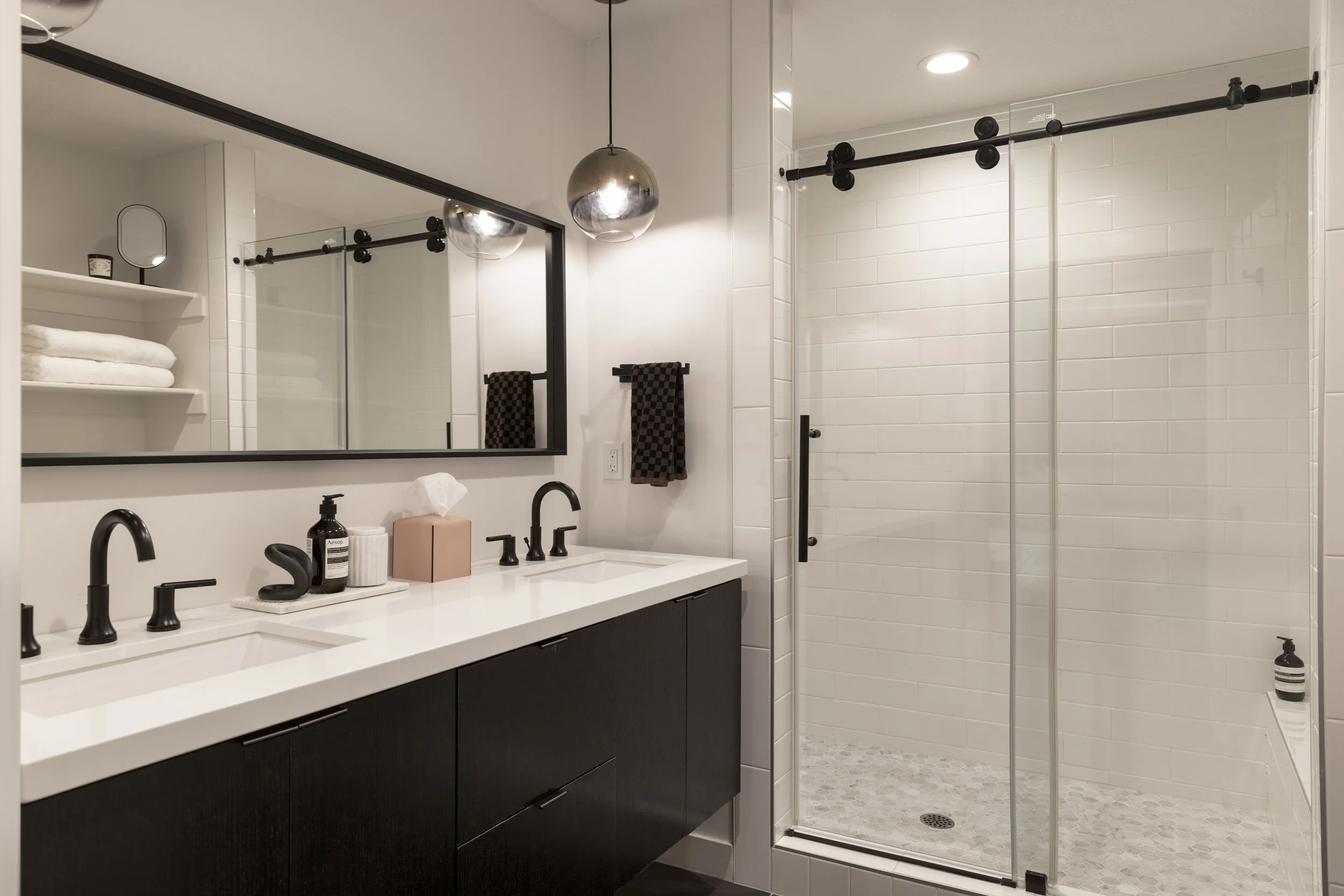 The primary bathroom offers flexibility for busy mornings with dual sinks and a water closet. The extra large walk in shower and bench are a welcome amenity after long ski days wear on legs. We're not fans of bright light - help yourself to the the f