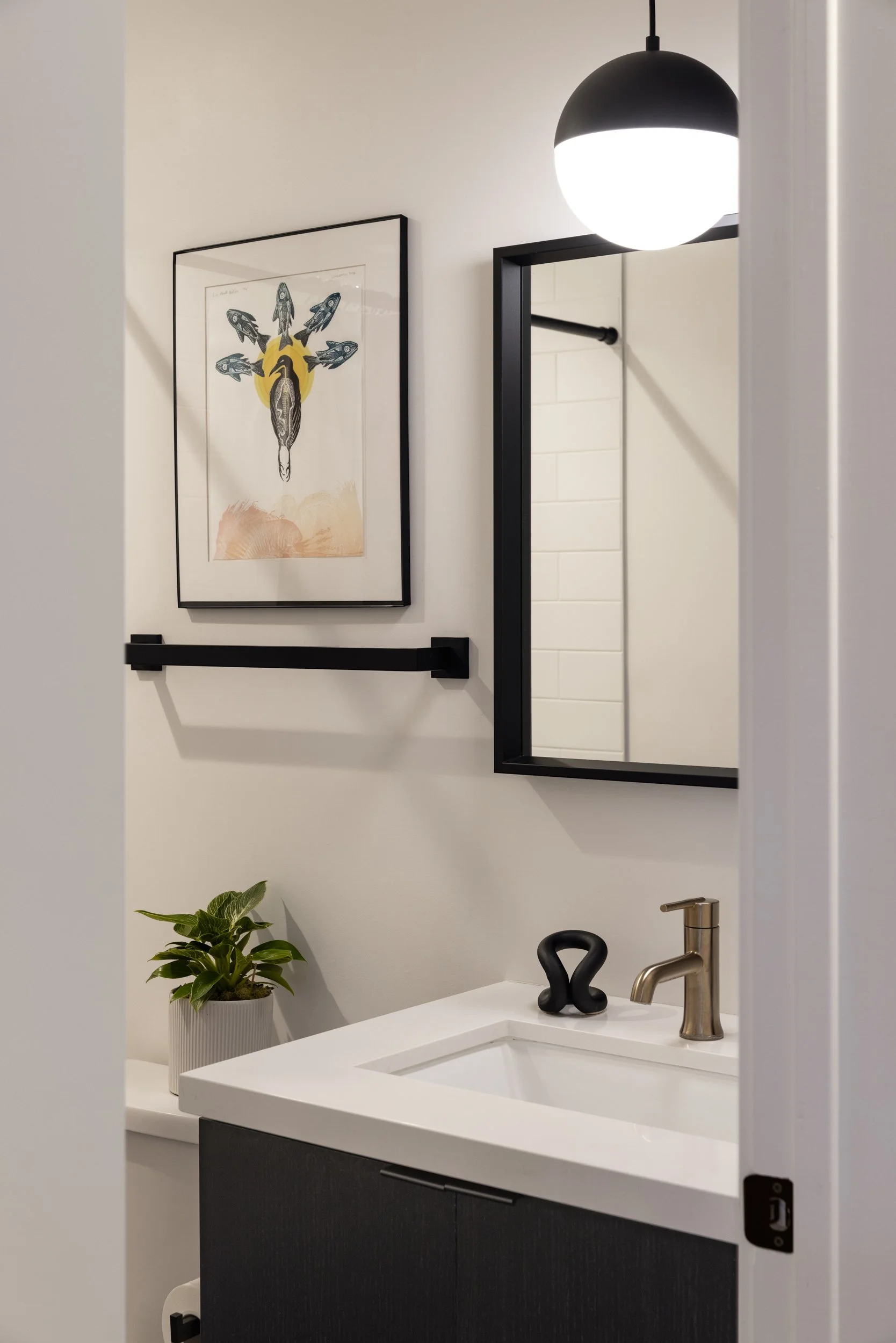 The first floor en suite full bath features thoughtful touches like Virginia Sin's Ood toothbrush holder, handmade in Brooklyn where we lived before we moved to Salt Lake, and art by Colorado artist, Johanna Mueller.