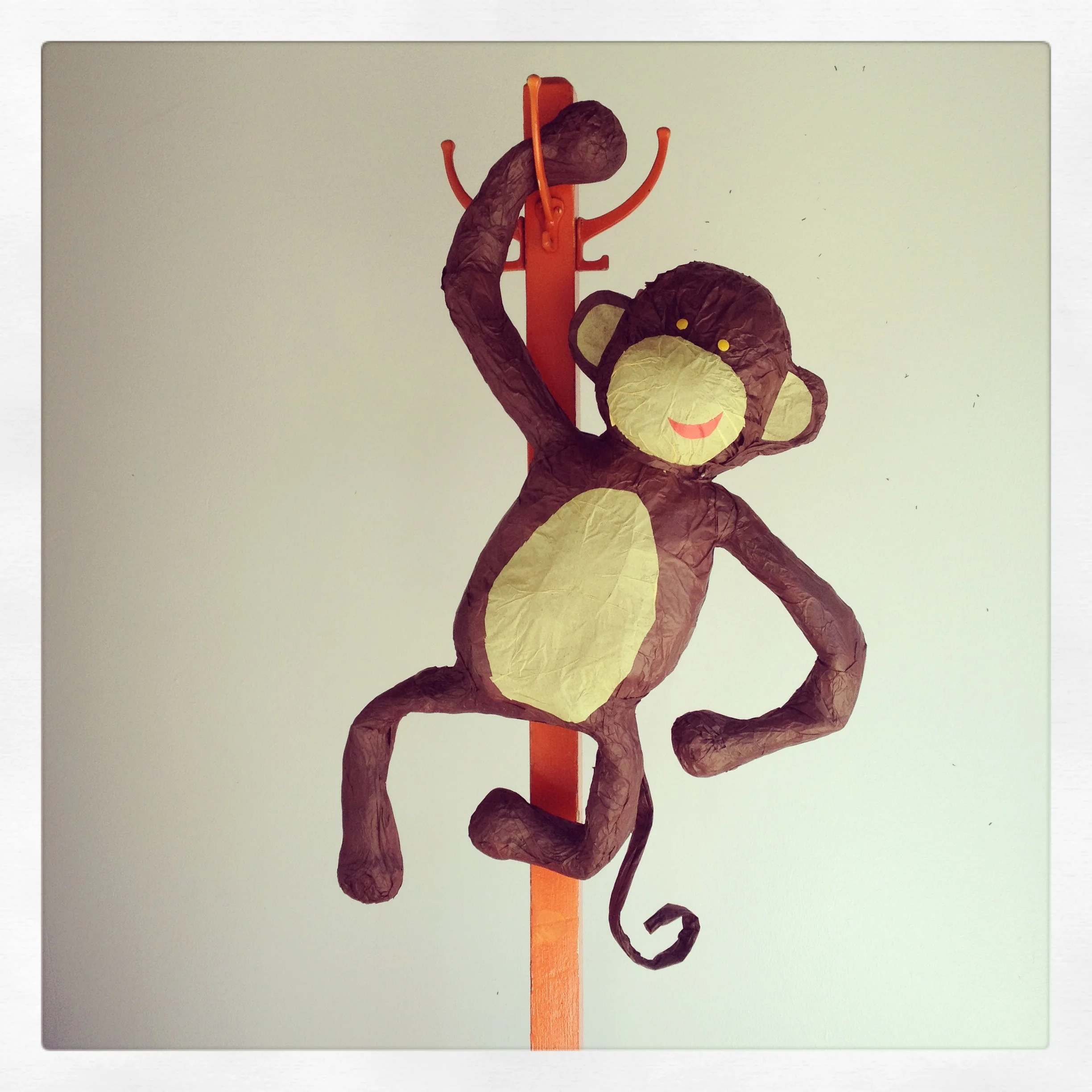 Paper lantern shaped like a monkey hanging on a wall
