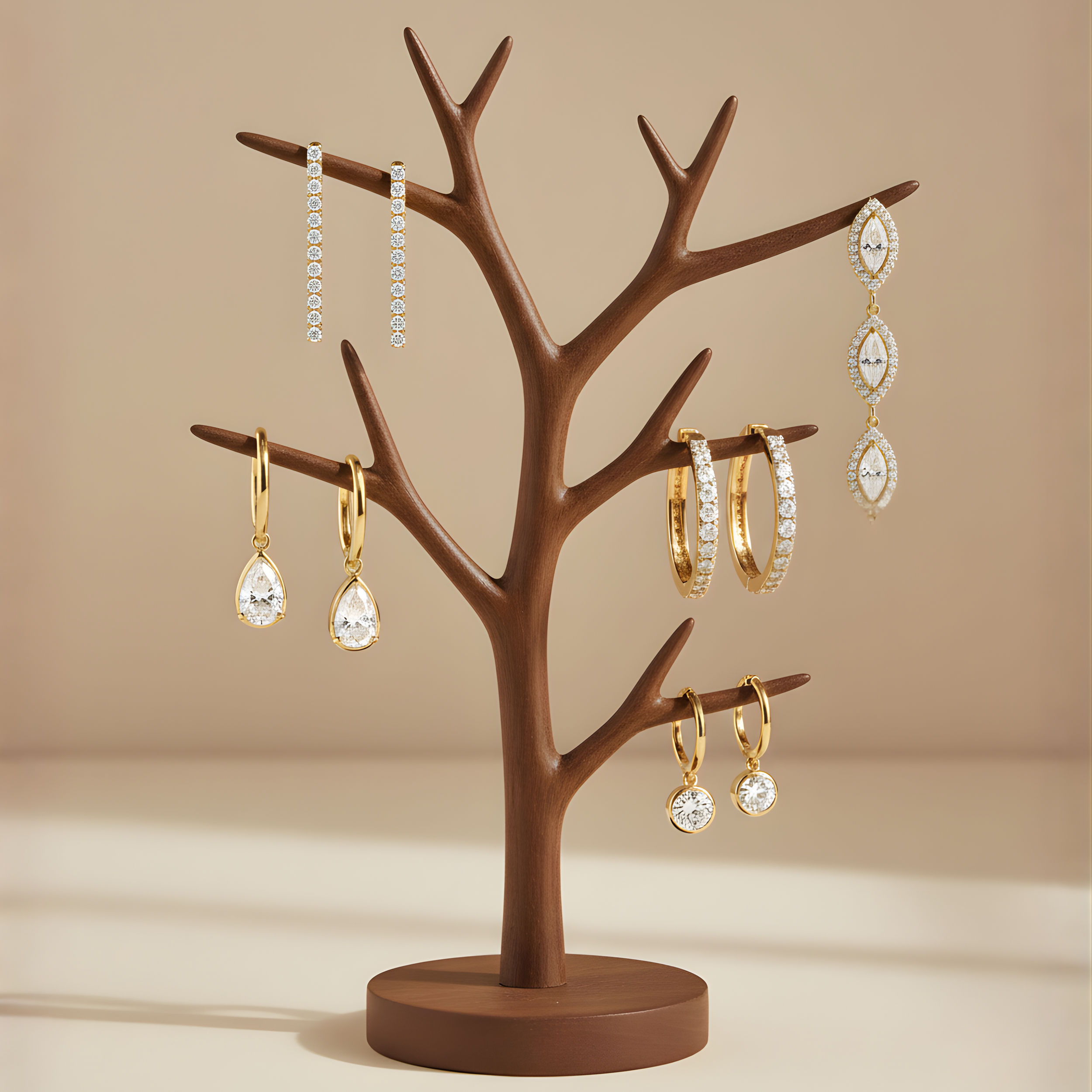 Jewelry display with earrings and rings hanging from a brown tree-shaped stand.