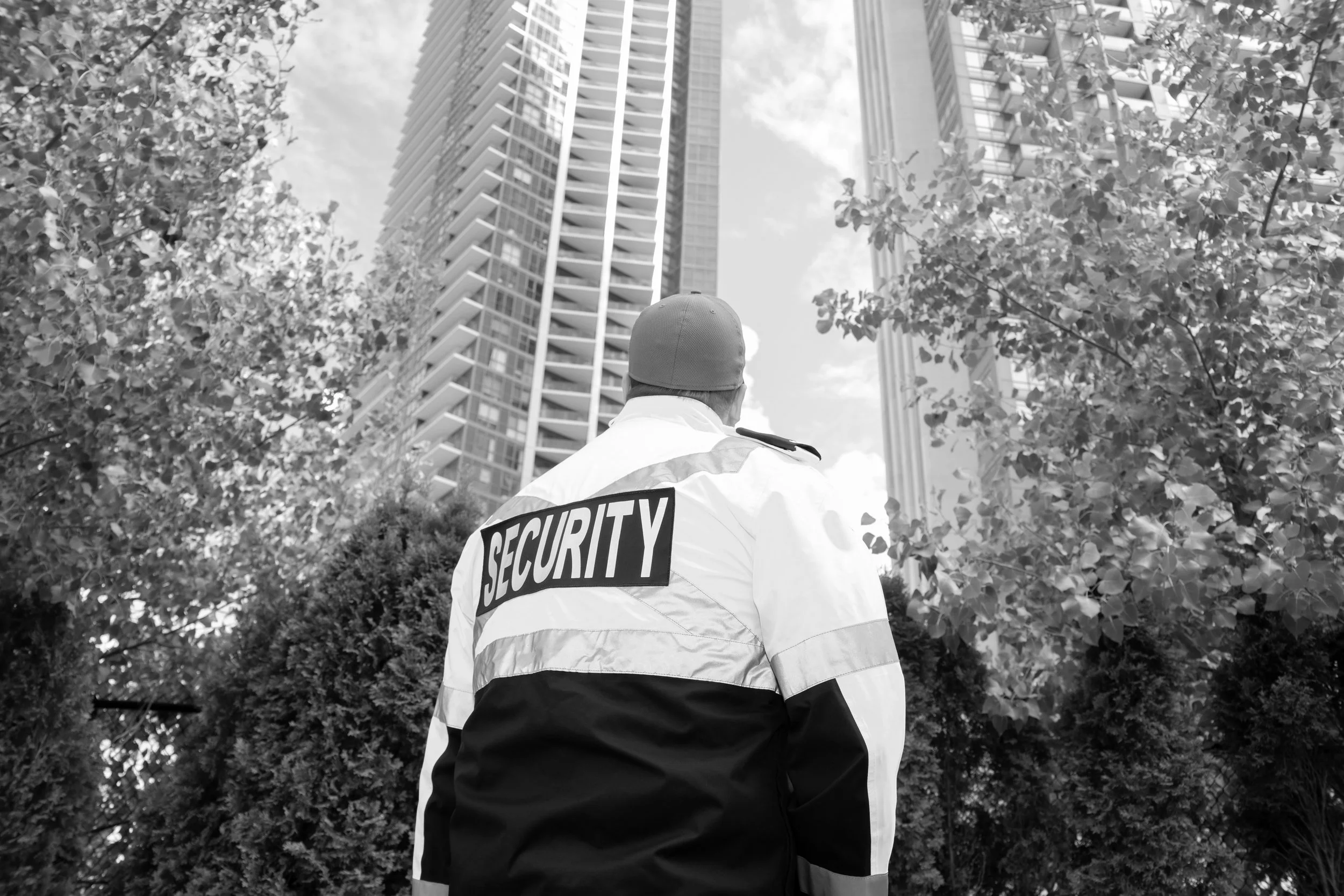 A security guard in uniform patrolling a residential area.jpg