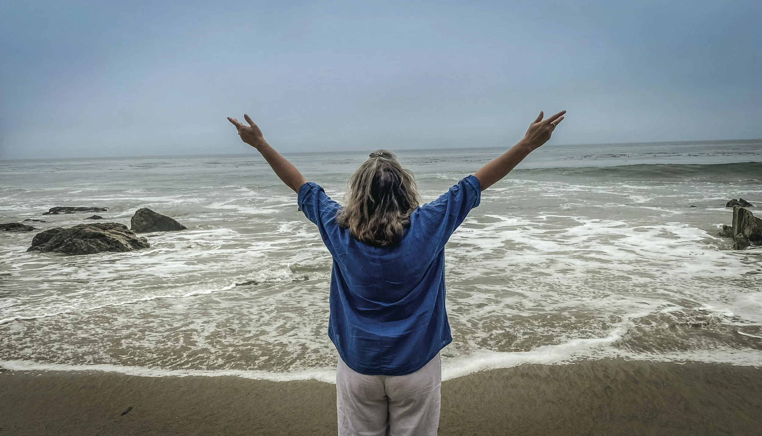 woman at beach loving her age at 50